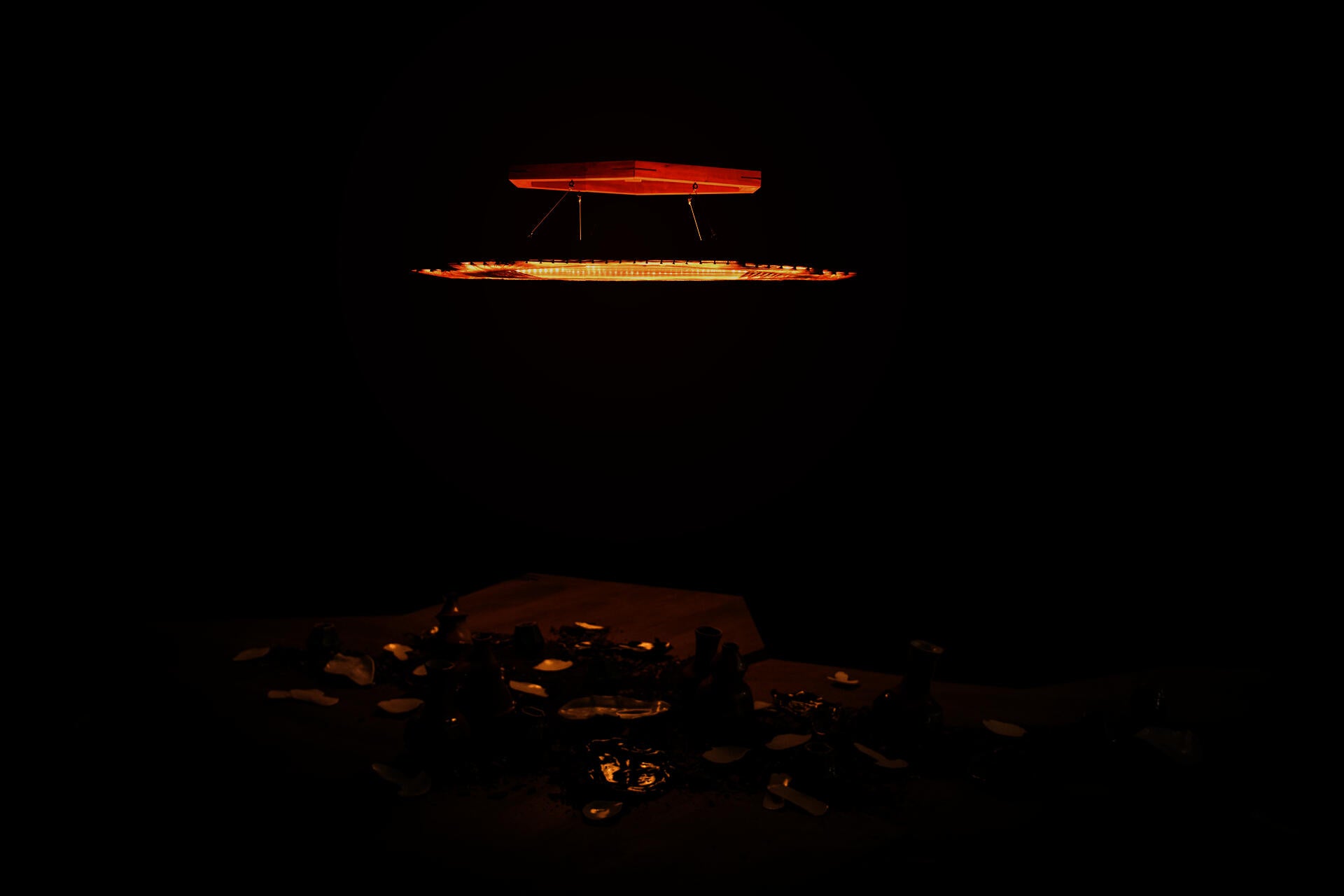 An unfamiliar platform, with barely visible objects on it. A low hanging Flame invites you.