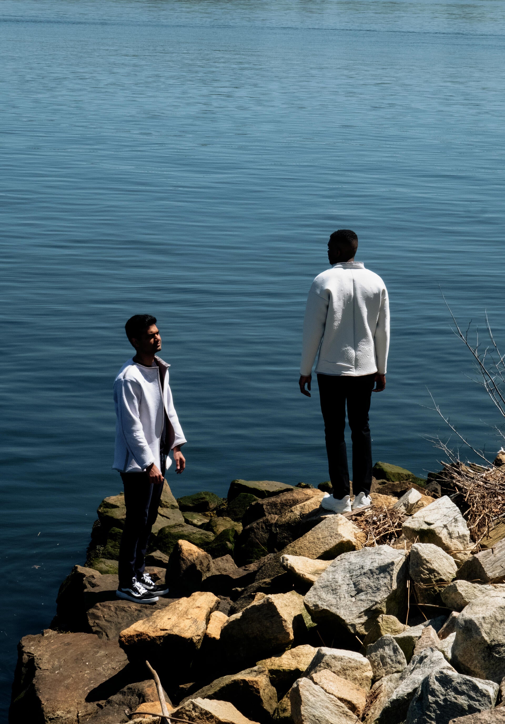 An image of two discreet humans, wearing garments applied with a phase-changing dye that reacts when in contact with volatile organic compounds.