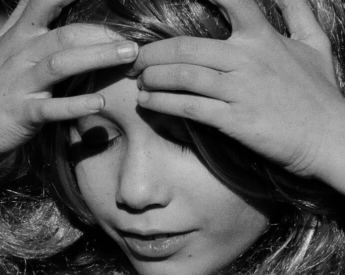young girl with eyes closed, touching fingertips to forehead, something mystical happening in her face