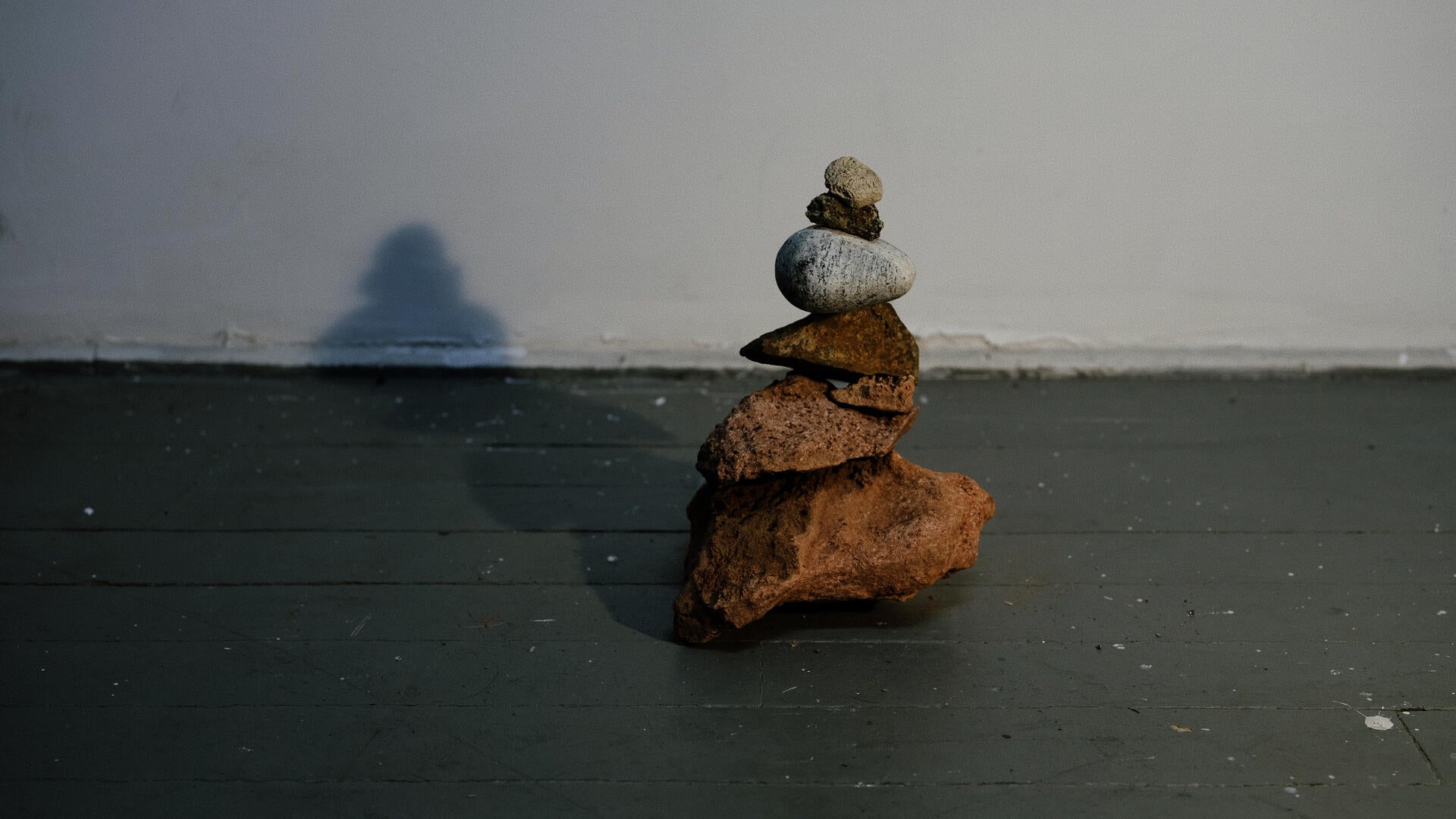 A pile of rocks in the shape of a cairn, or navigation sign.
