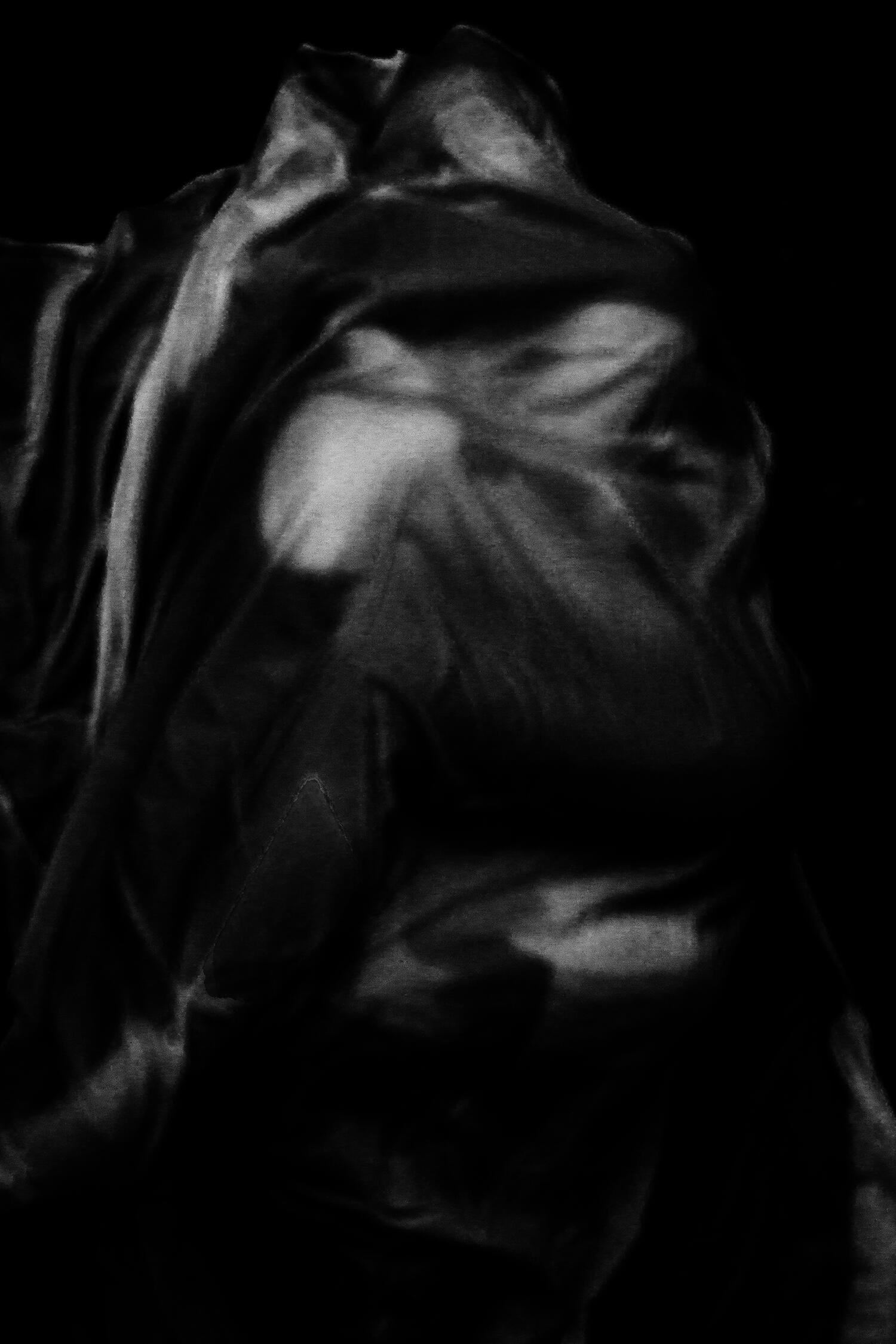 Two figures draped in fabric wrapping around each other.