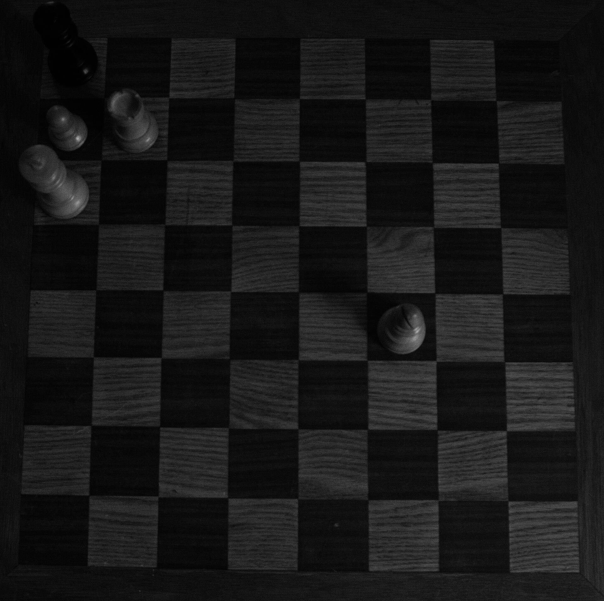 Hand made chess board with pieces displaying a stale mate.