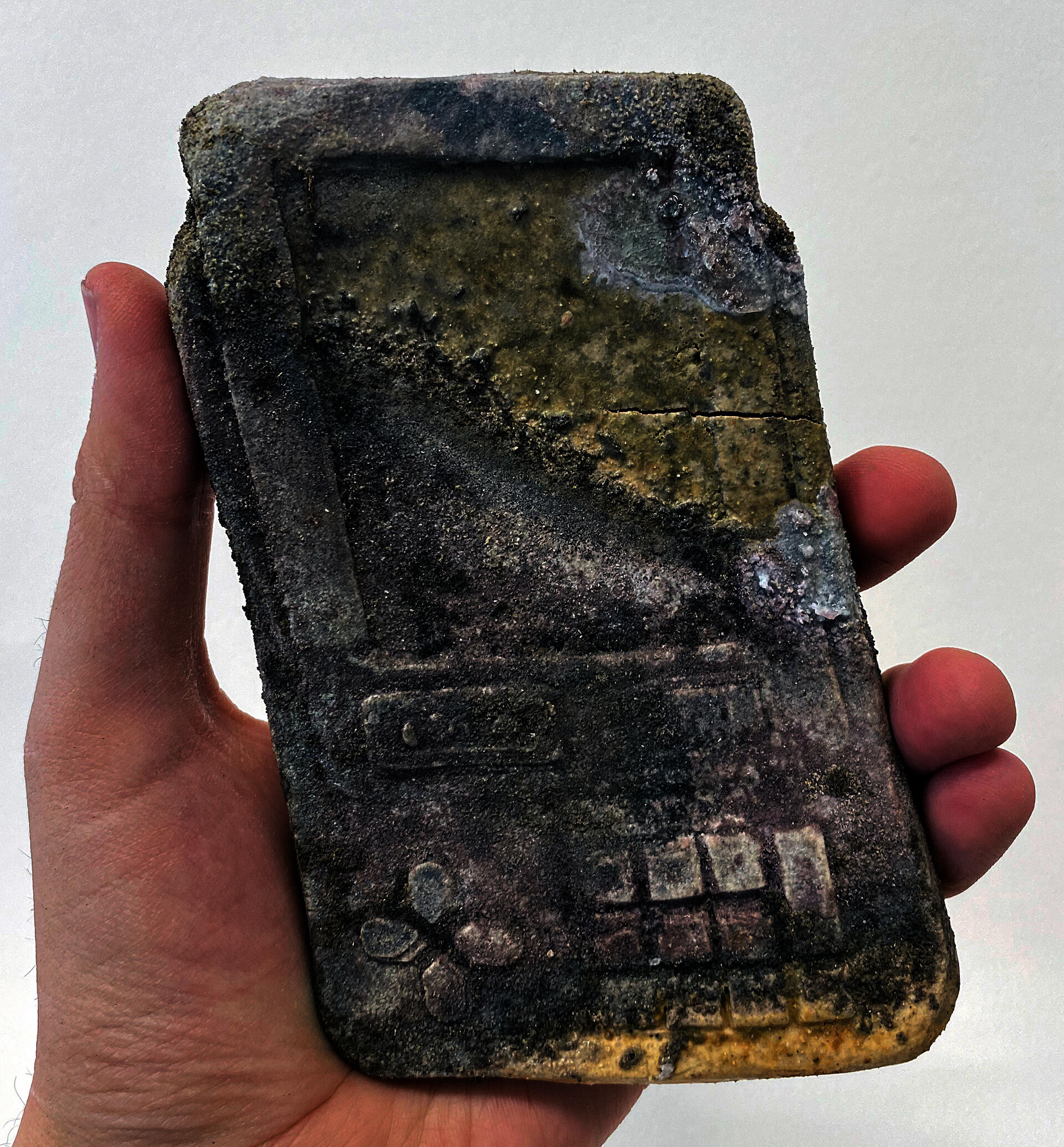 a phone like device with a textured wood fired finish