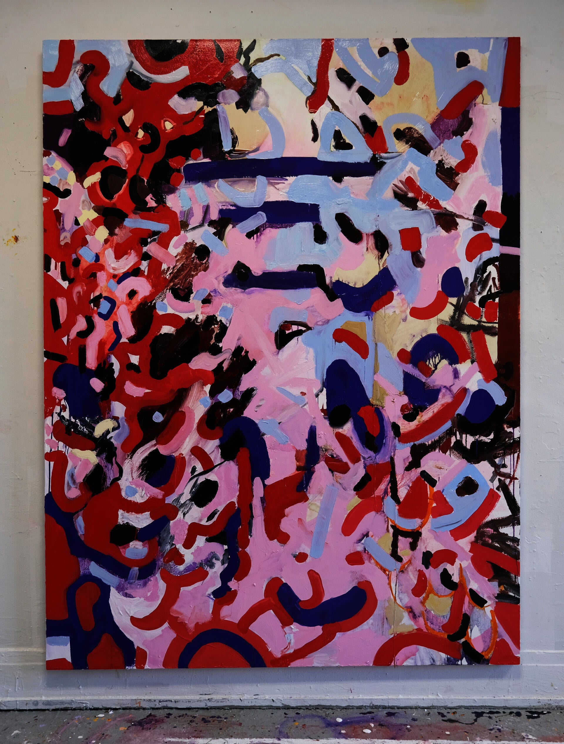 A vertical abstract painting with a red, pink, purple, and blue color pallet.
