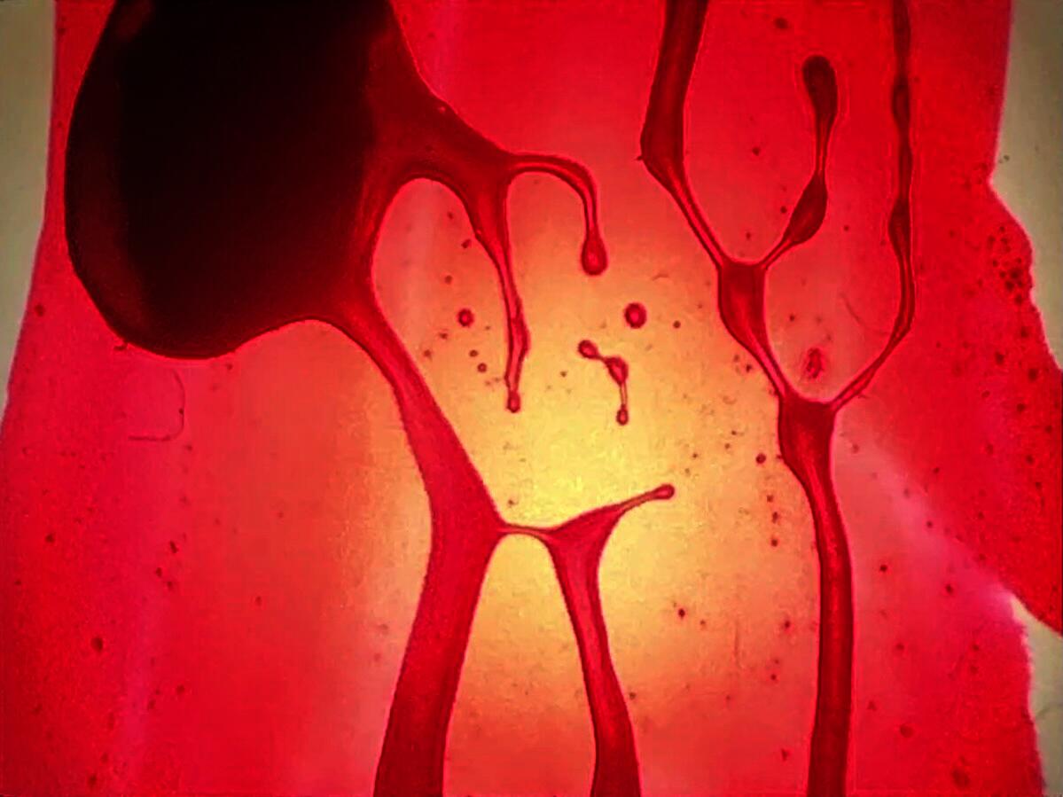 organic form showered under red paint