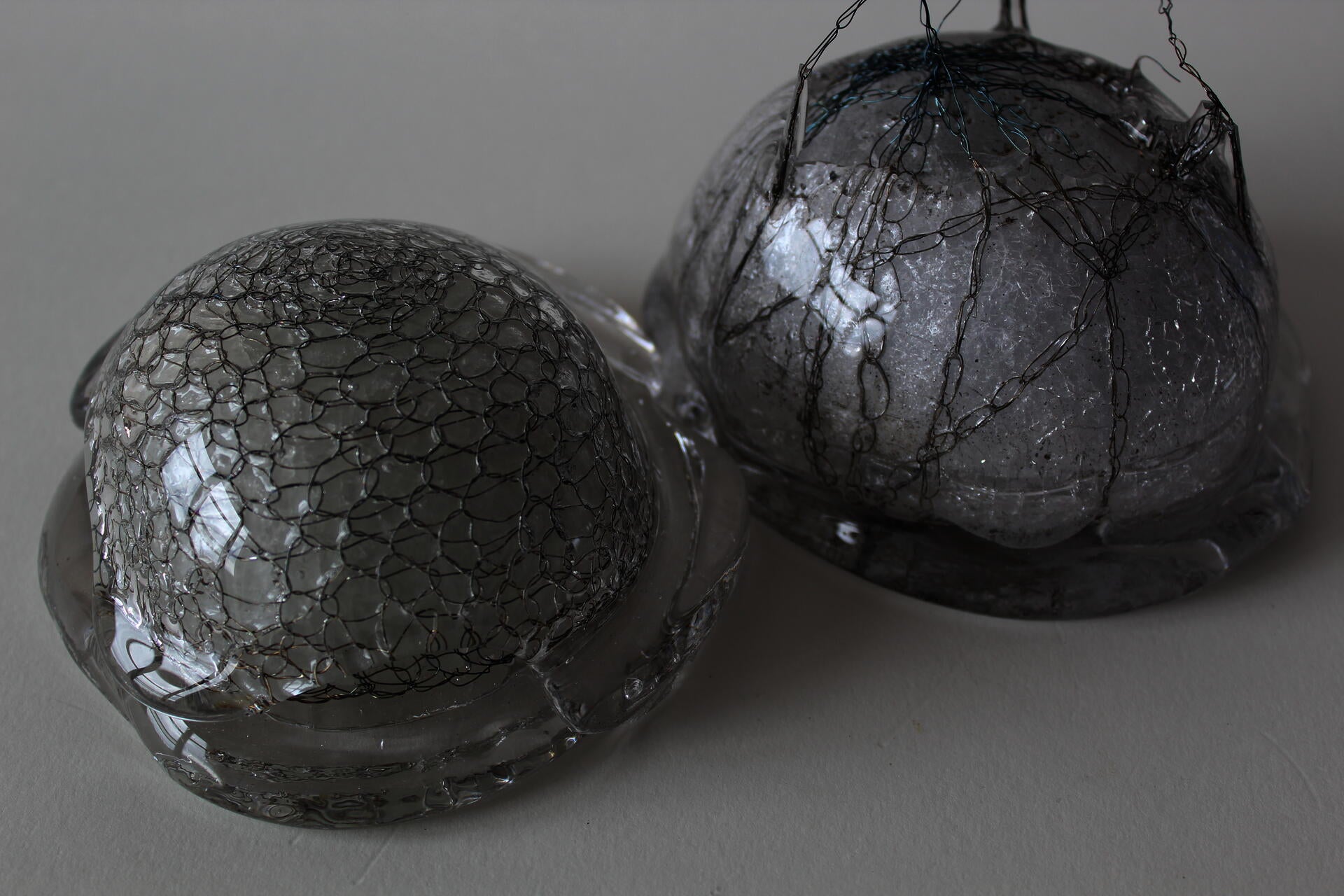 Two glass objects in the shape of half domes.