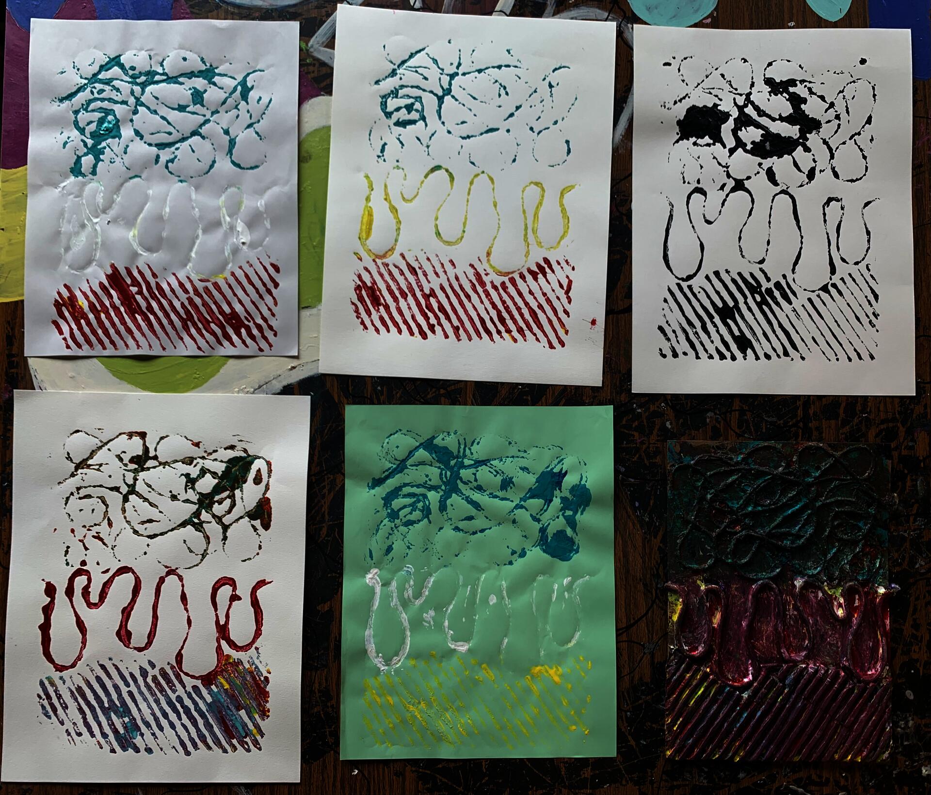 Various colored prints made from a collagraph plate. The theme was centered around music and what it means to them. In this student’s case, he connects with various genres and used a variety of lines to replicate how they feel to him.