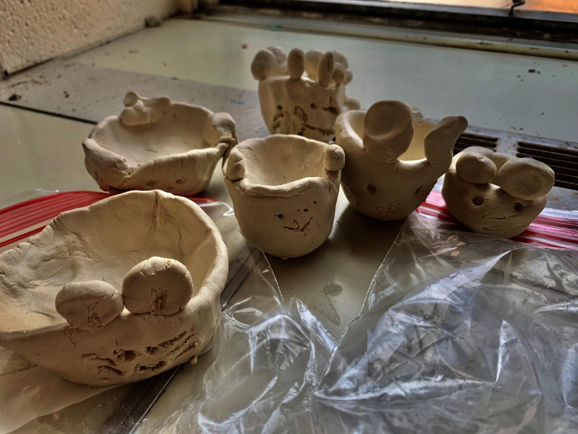Variously sized pinch pots that represent different items that the children deemed important to them