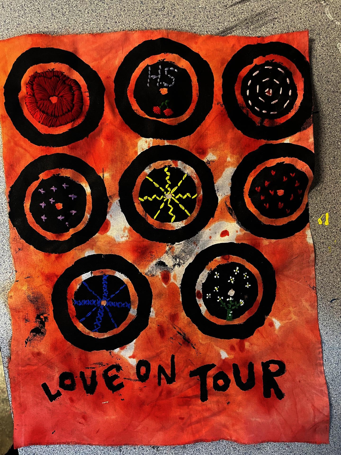 Tapestry that is silkscreened with various embroidery designs on top