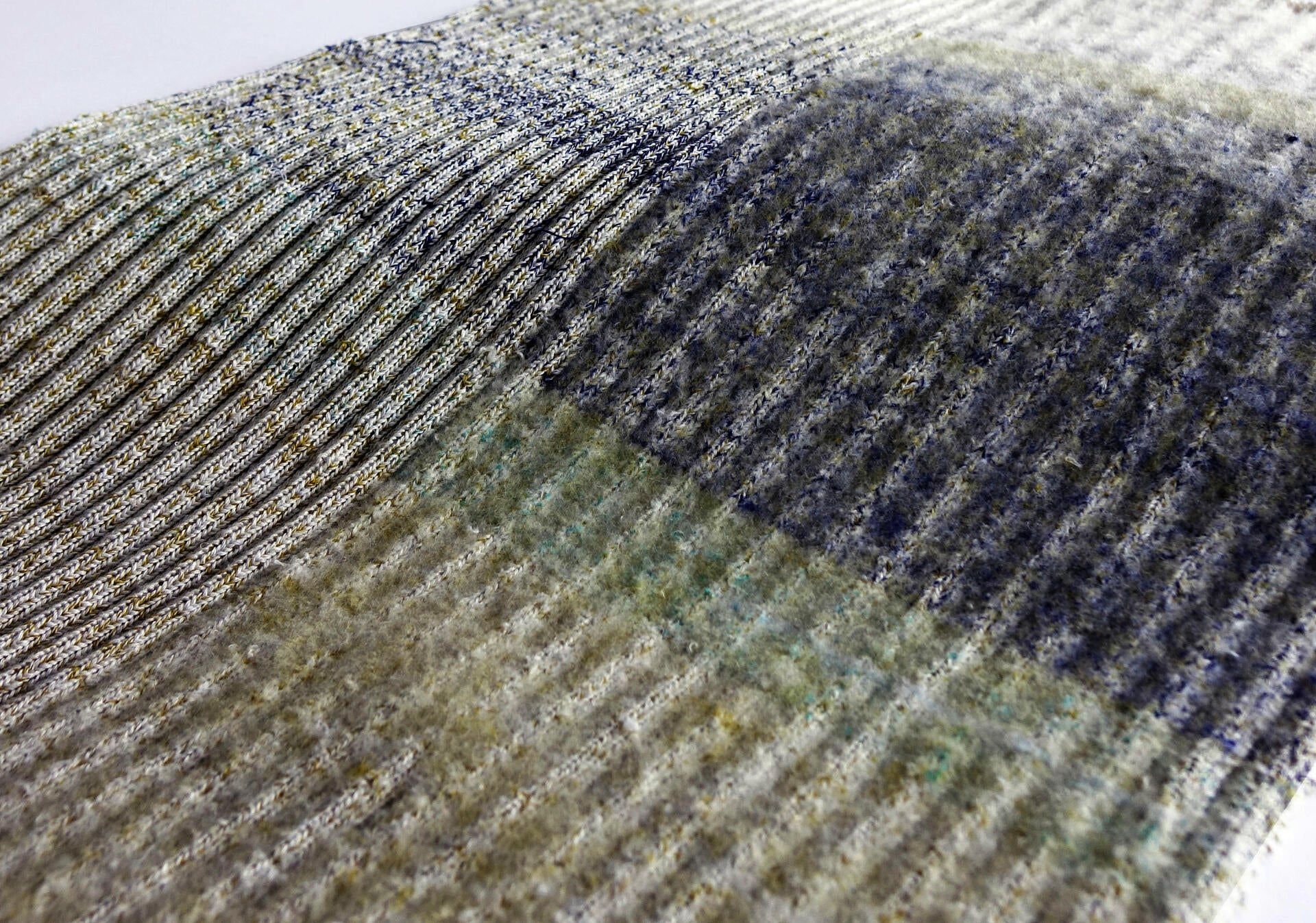 Knitted sample with textured ridges and is fuzzy on one half