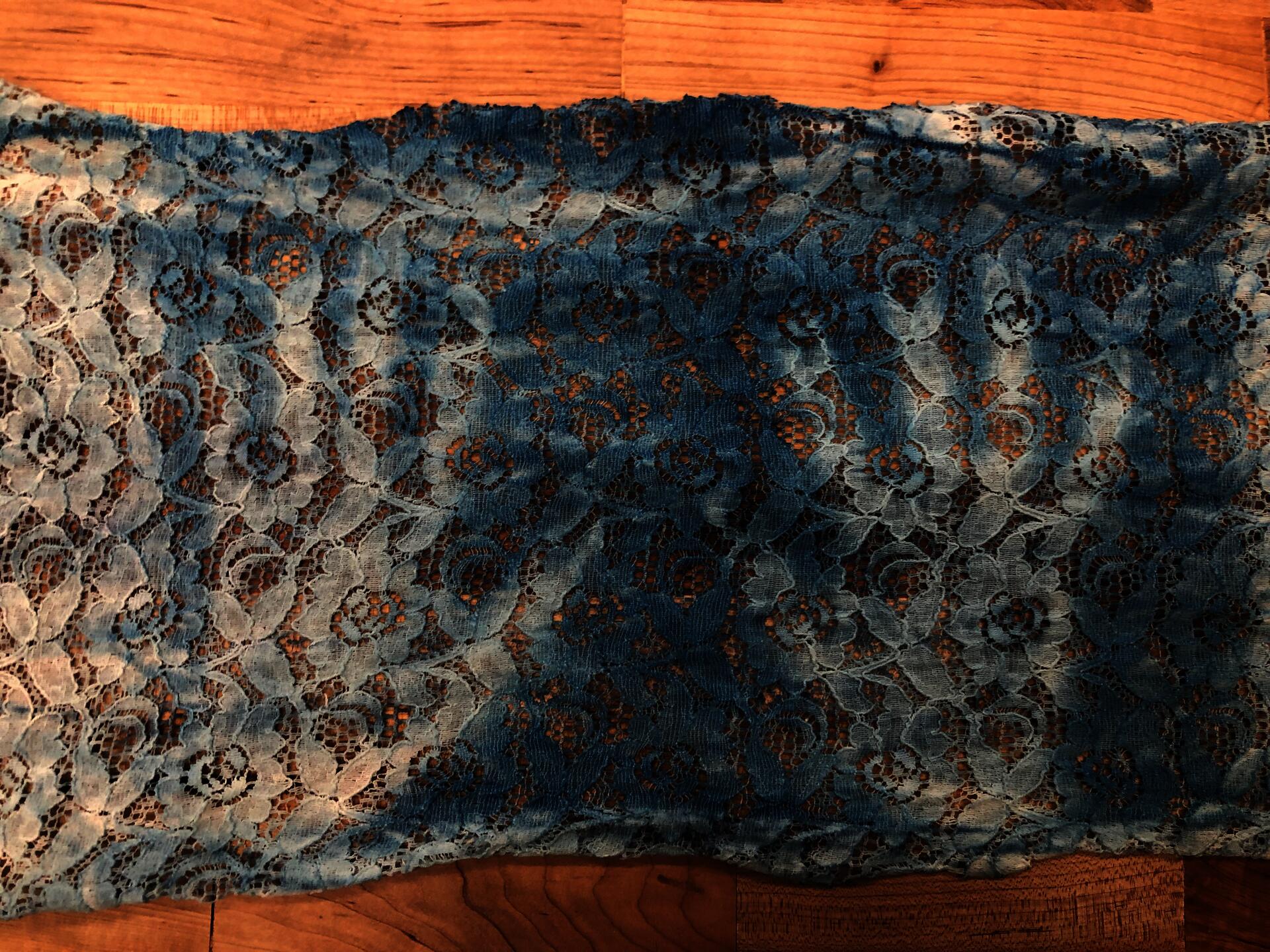 Remnants of handprints on lace due to cyanotype.