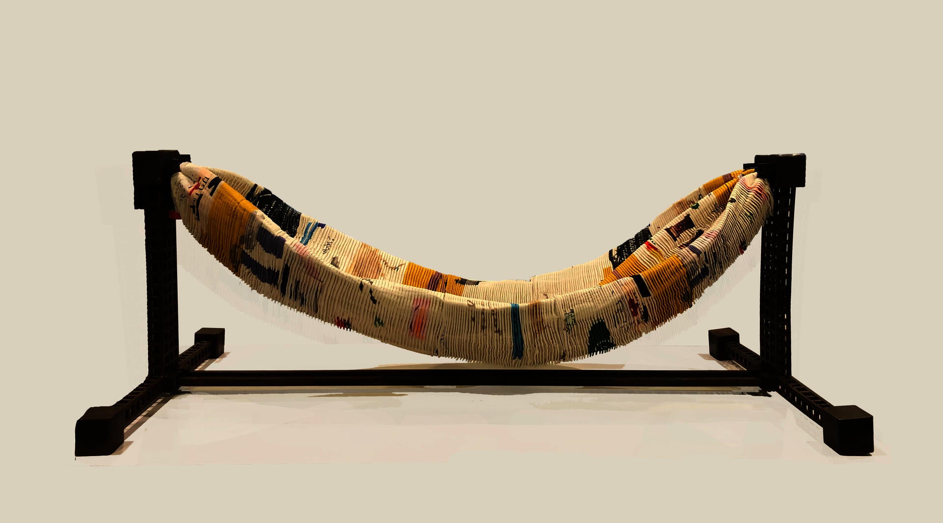 A flat, narrow base with supporting columns at either end, holding in the center a suspended hammock made to specifically cradle and offer belonging to the user. Don't Remind me is meant to offer psychological relief as well as physical comfort, gently speaking to the basic human need for balance.
