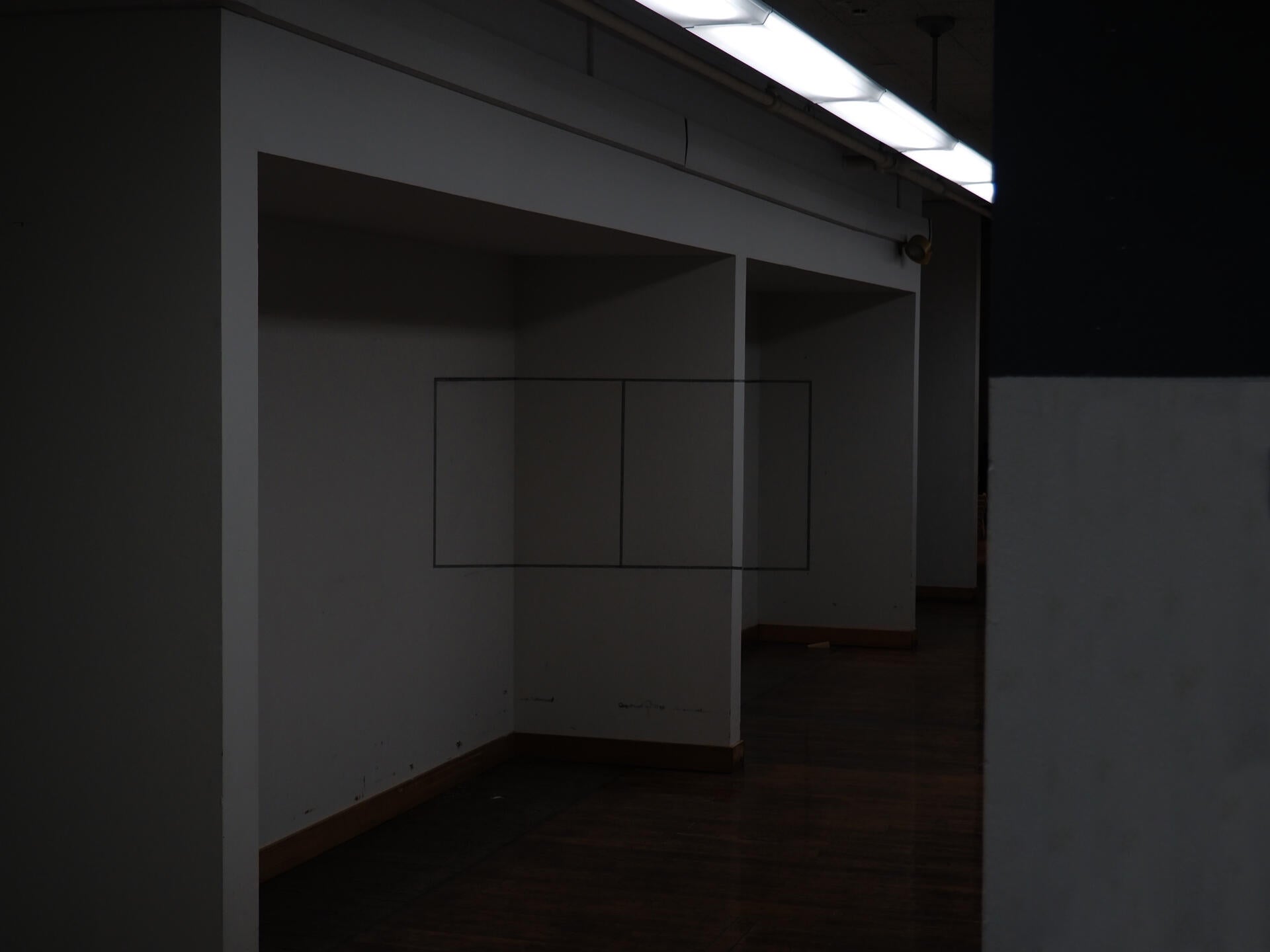 A pair of what appear to be flat squares drawn along the length of a hallway.