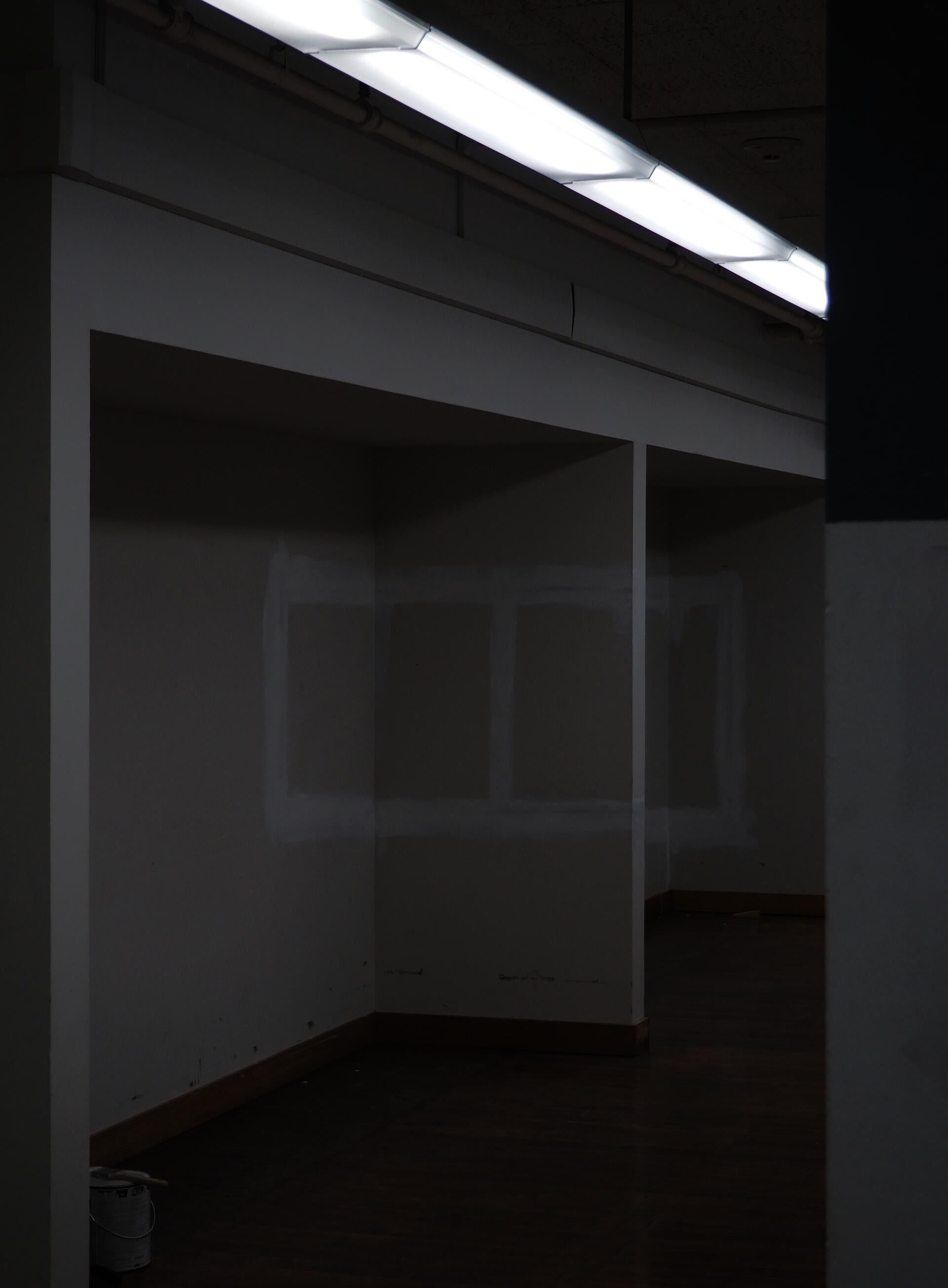 A pair of white painted squares drawn along a hallway.