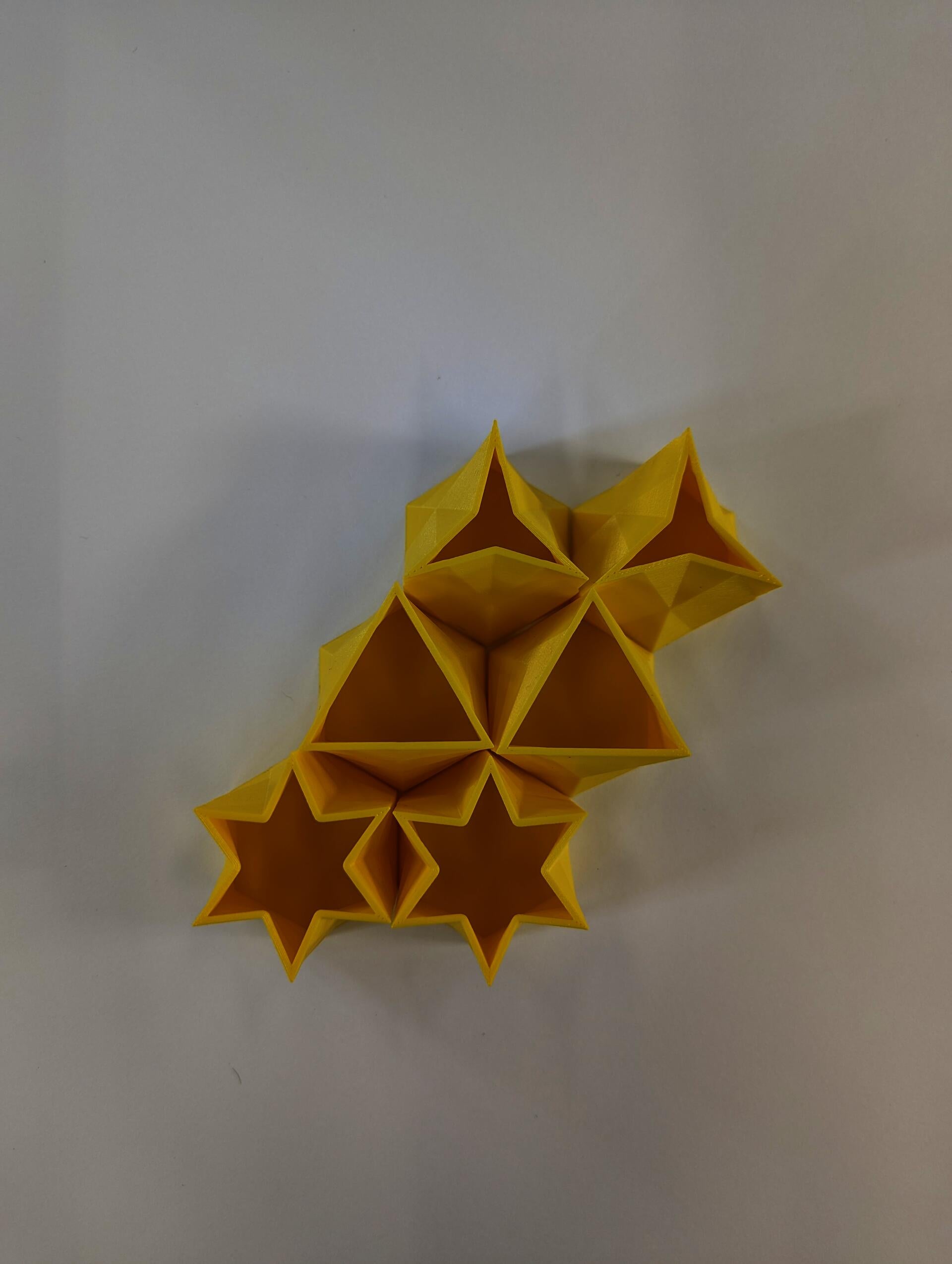 Small 3D printed extrusions translate from hexagons to triangles and other shapes.