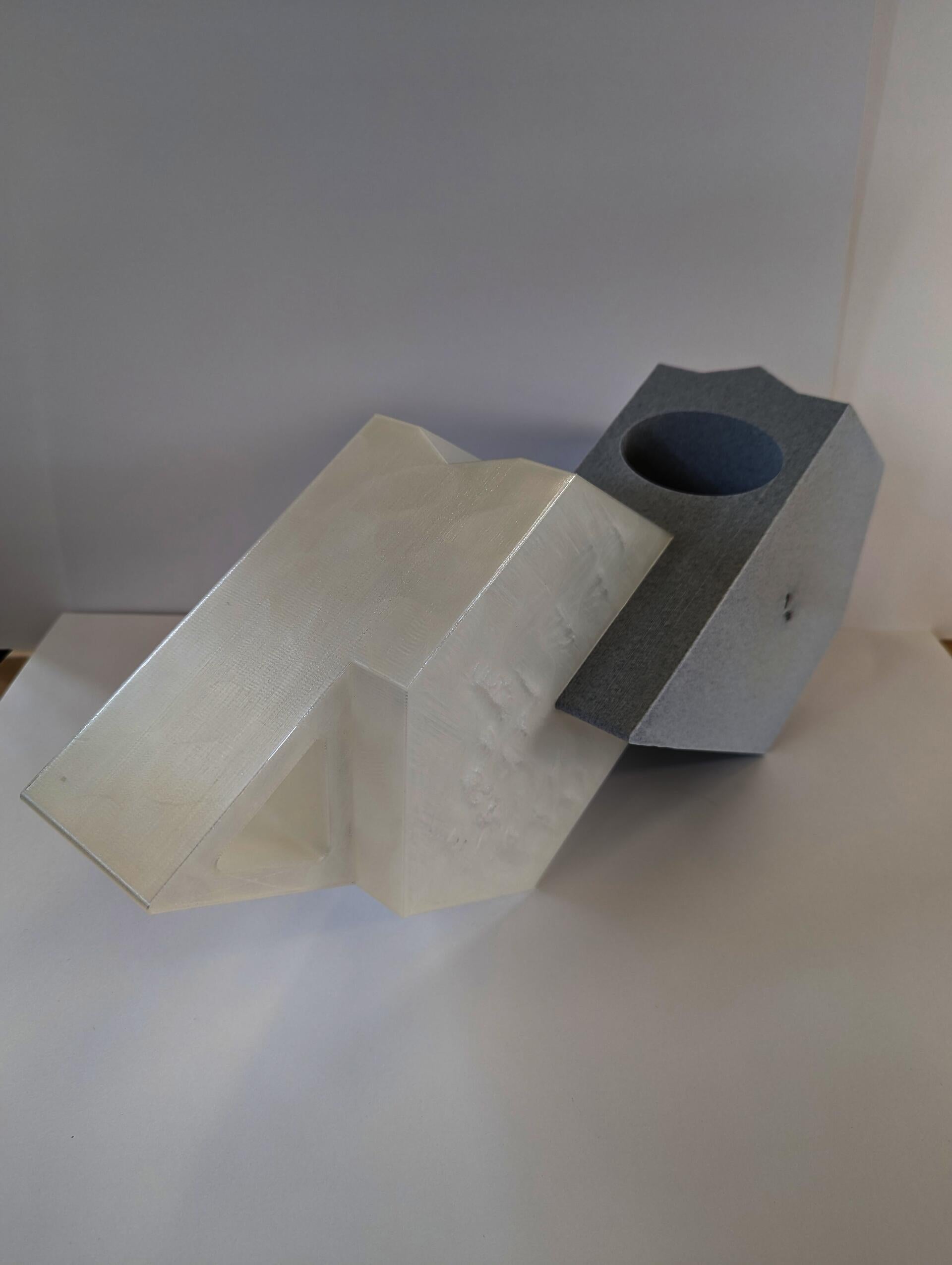Two full size 3D printed hexagon blocks are partially interlocked.
