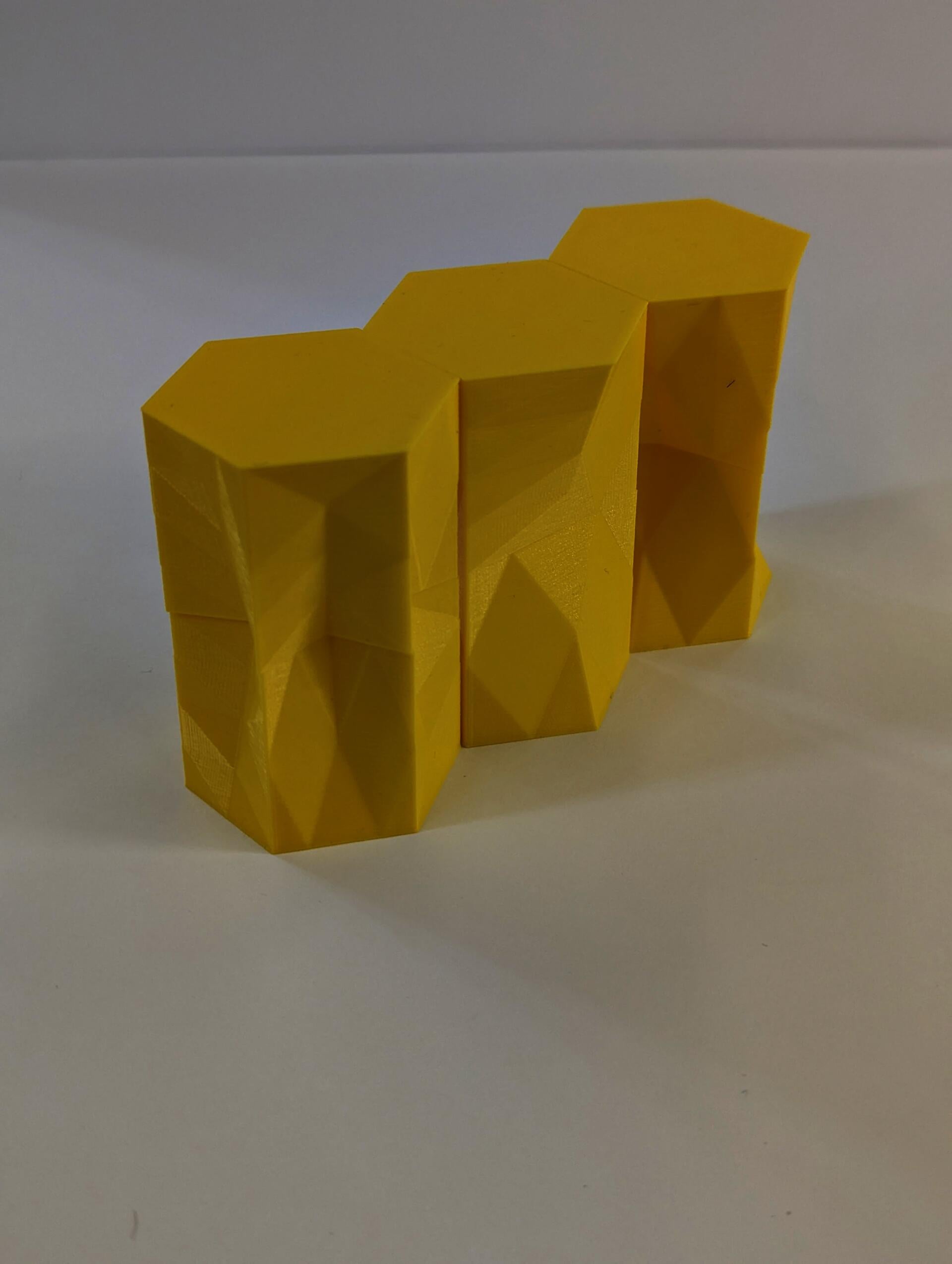 Small 3D printed extrusions translate from hexagons to other shapes and back to hexagons.