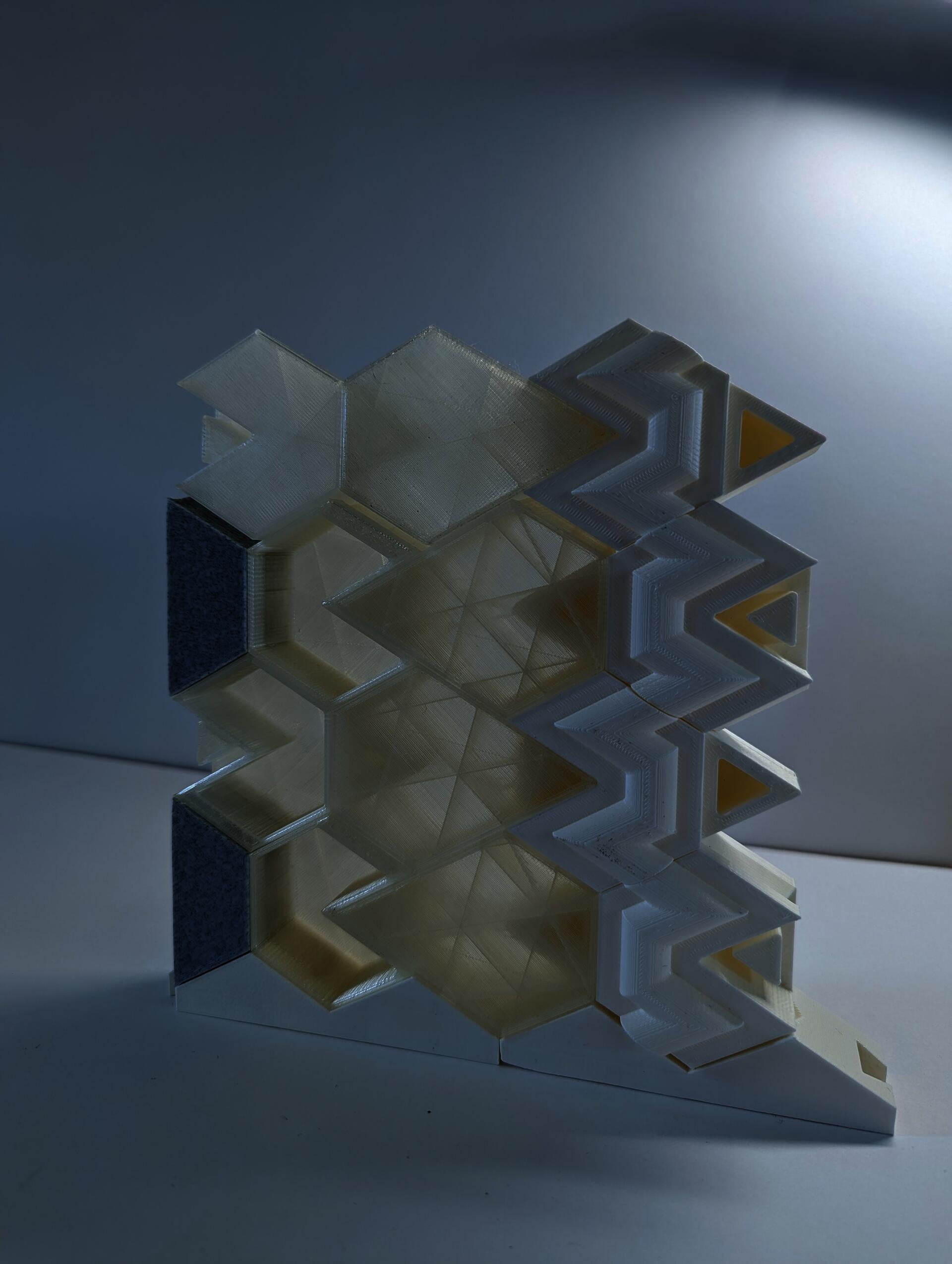 Hexagon based building blocks made from translucent filament are stacked as a scale wall assembly.