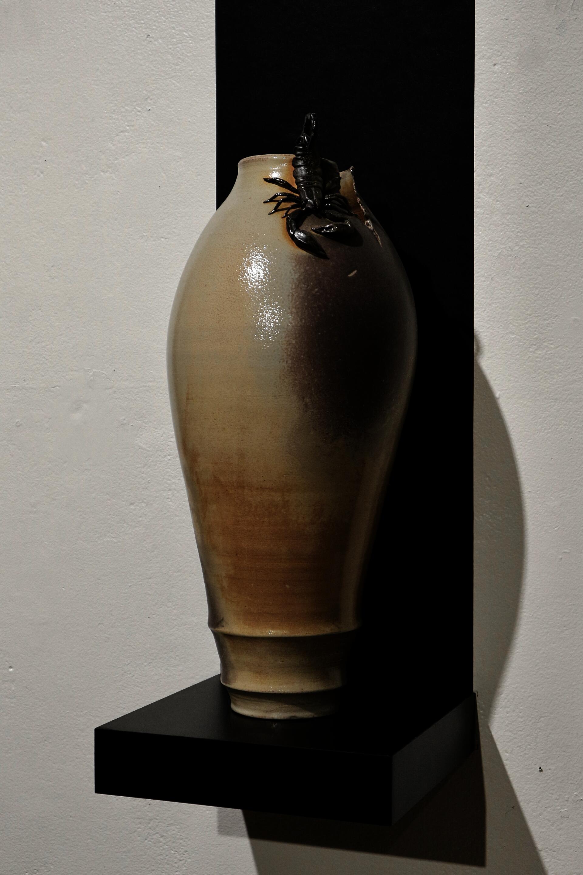 Soda-fired ceramic vessel with hand-sculpted scorpion around the neck.