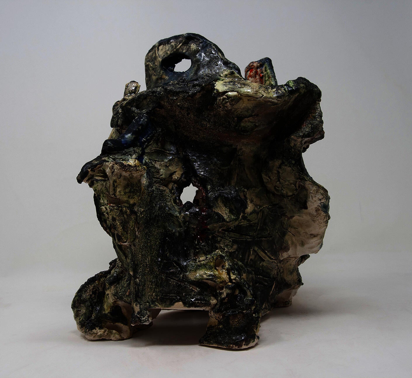 Ceramic object in the shape of a broken helmet with textural glaze