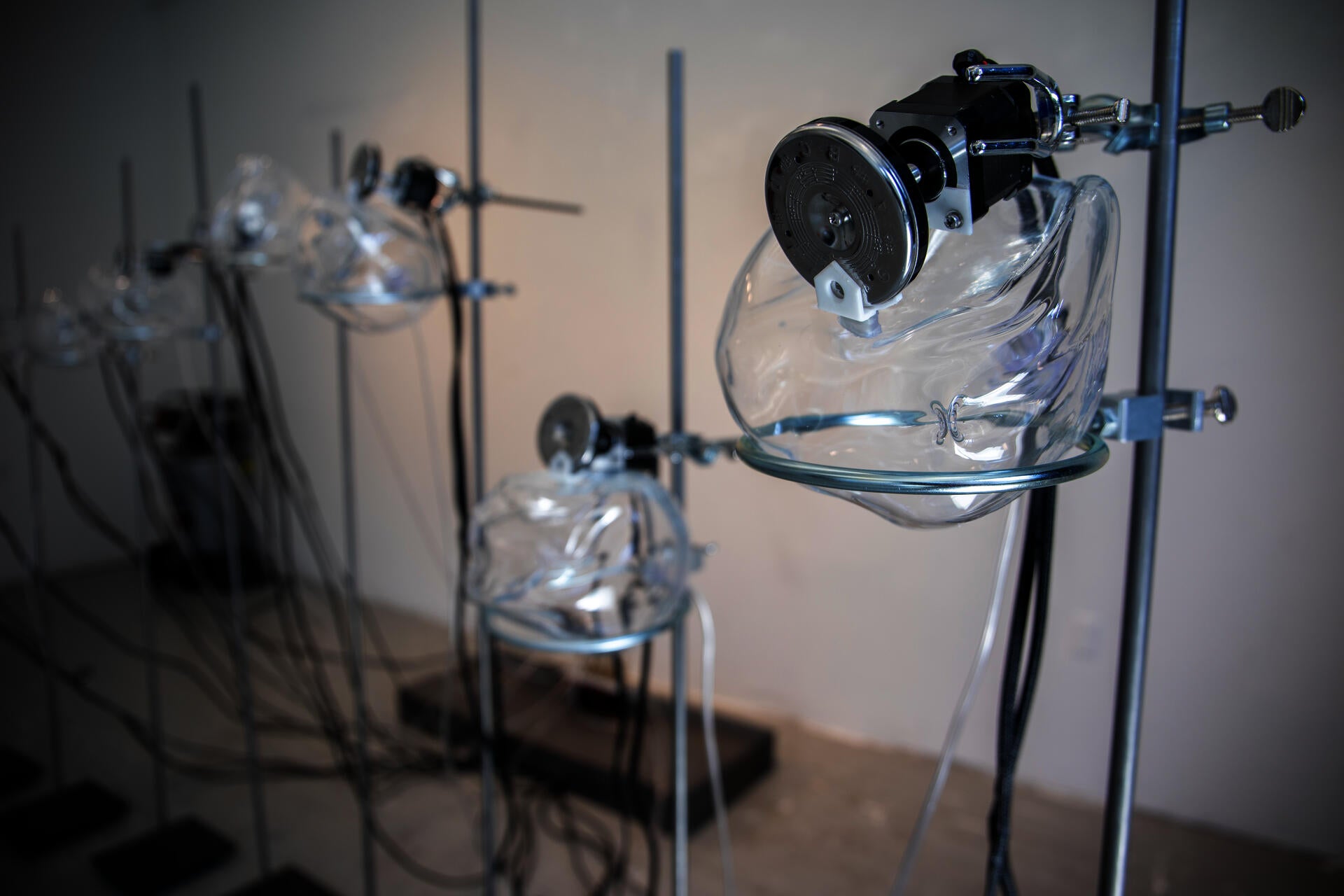 Nine steel stands with glass orbs define a semicircle in the exhibition space with multiple sonic and kinetic elements.