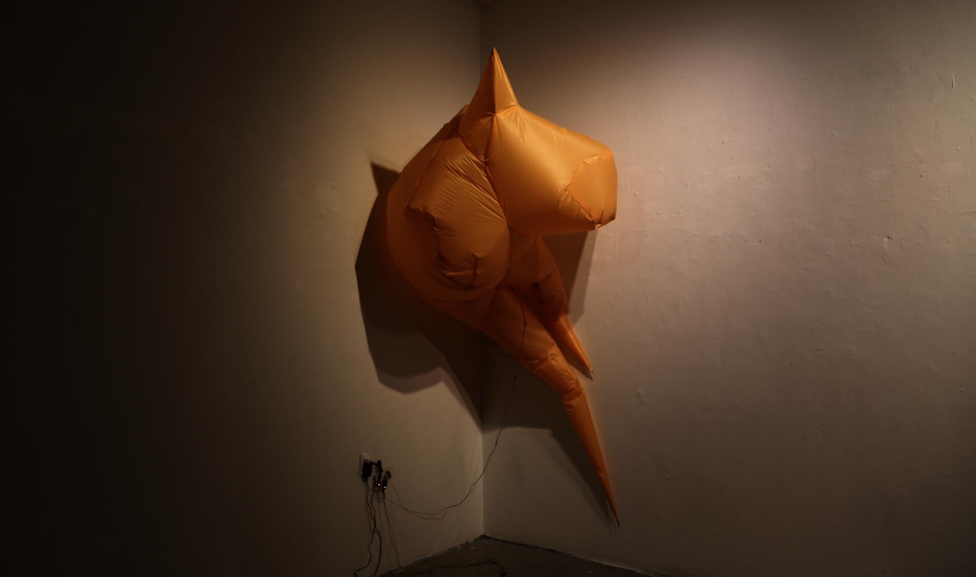 A fully inflated, mirage-like inflatable object made of fabric.