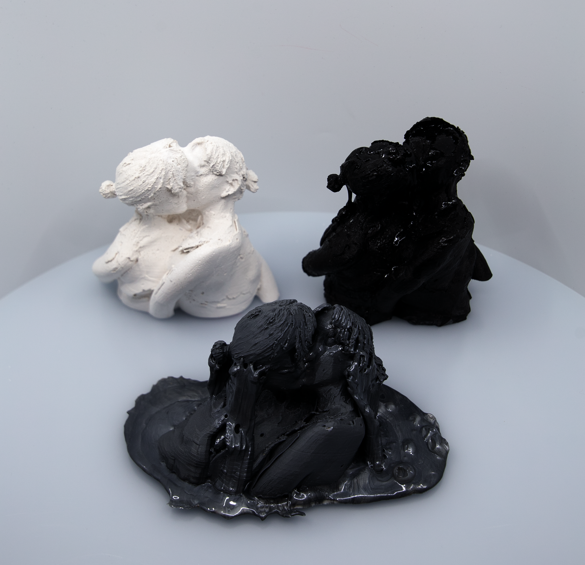 Multiple images of different small sculptures of varying materials flash on screen.