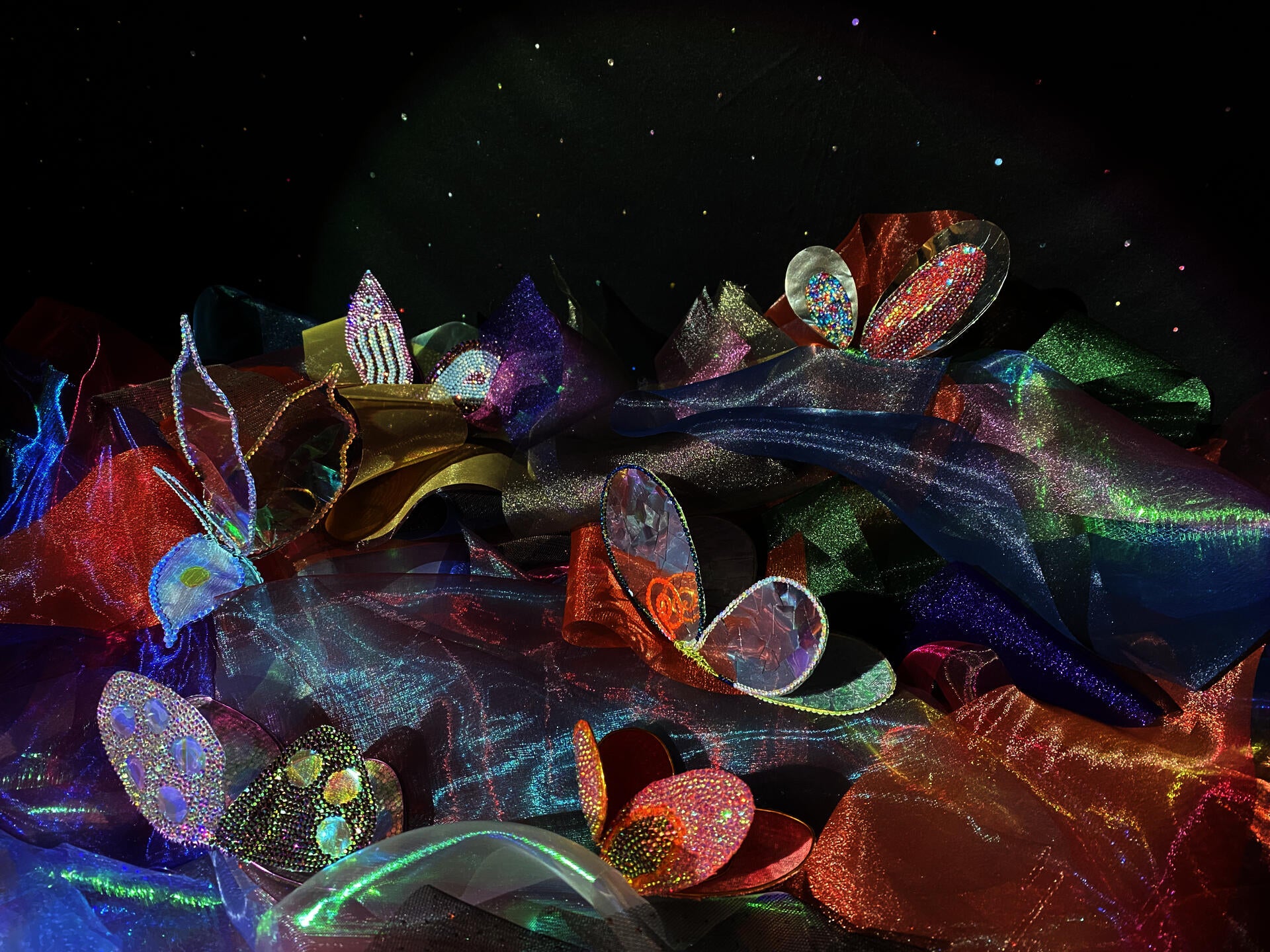 Handcrafted butterflies amongst a mixture of organza fabric. 