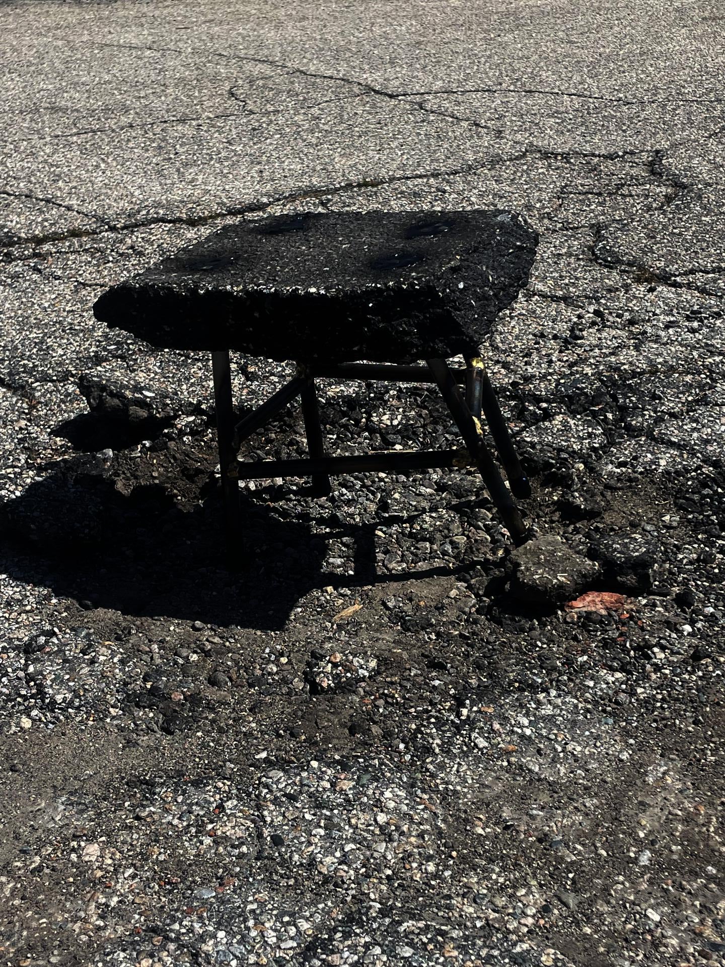 Asphalt stool on damaged roadway