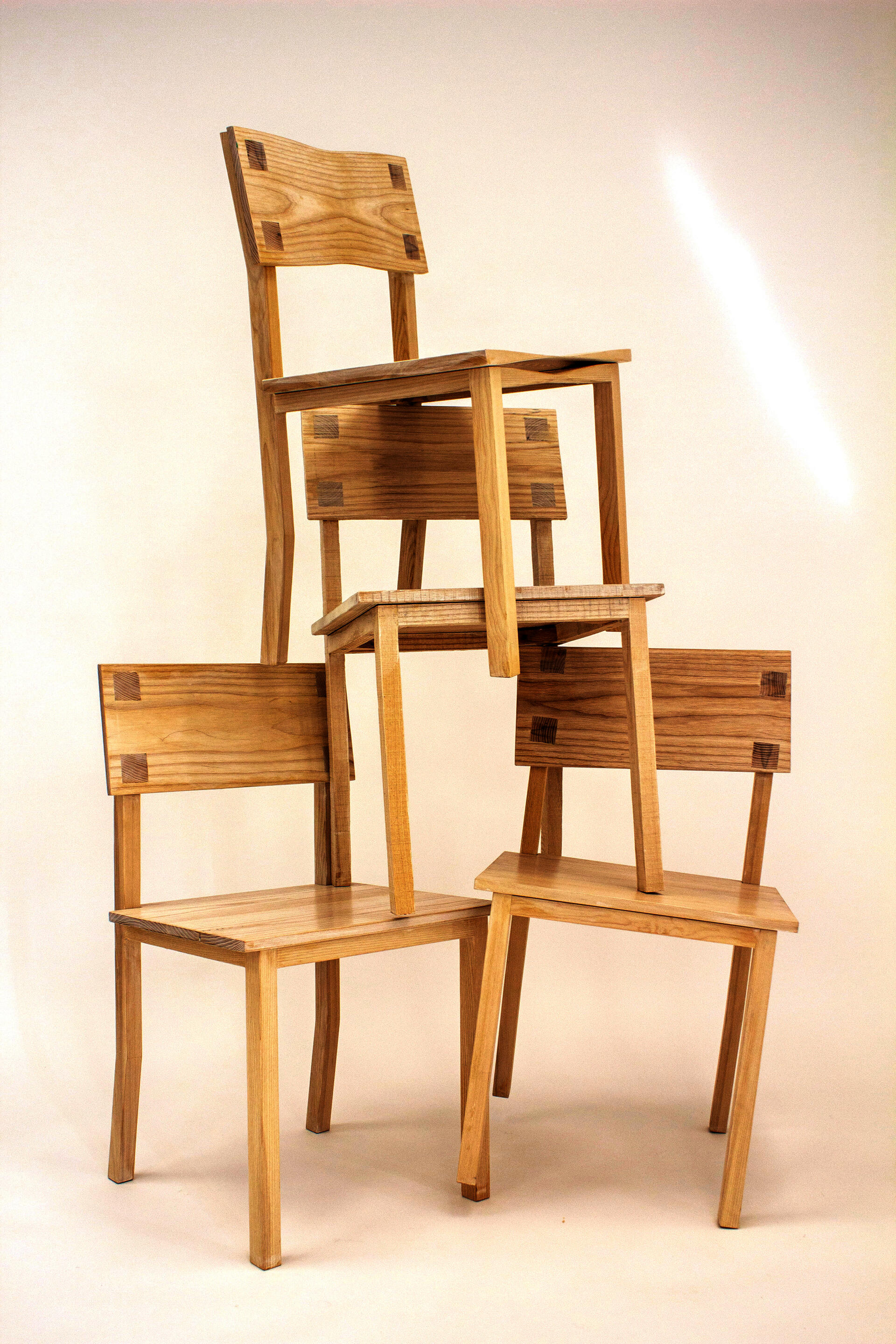 Group of dining chairs upon one another