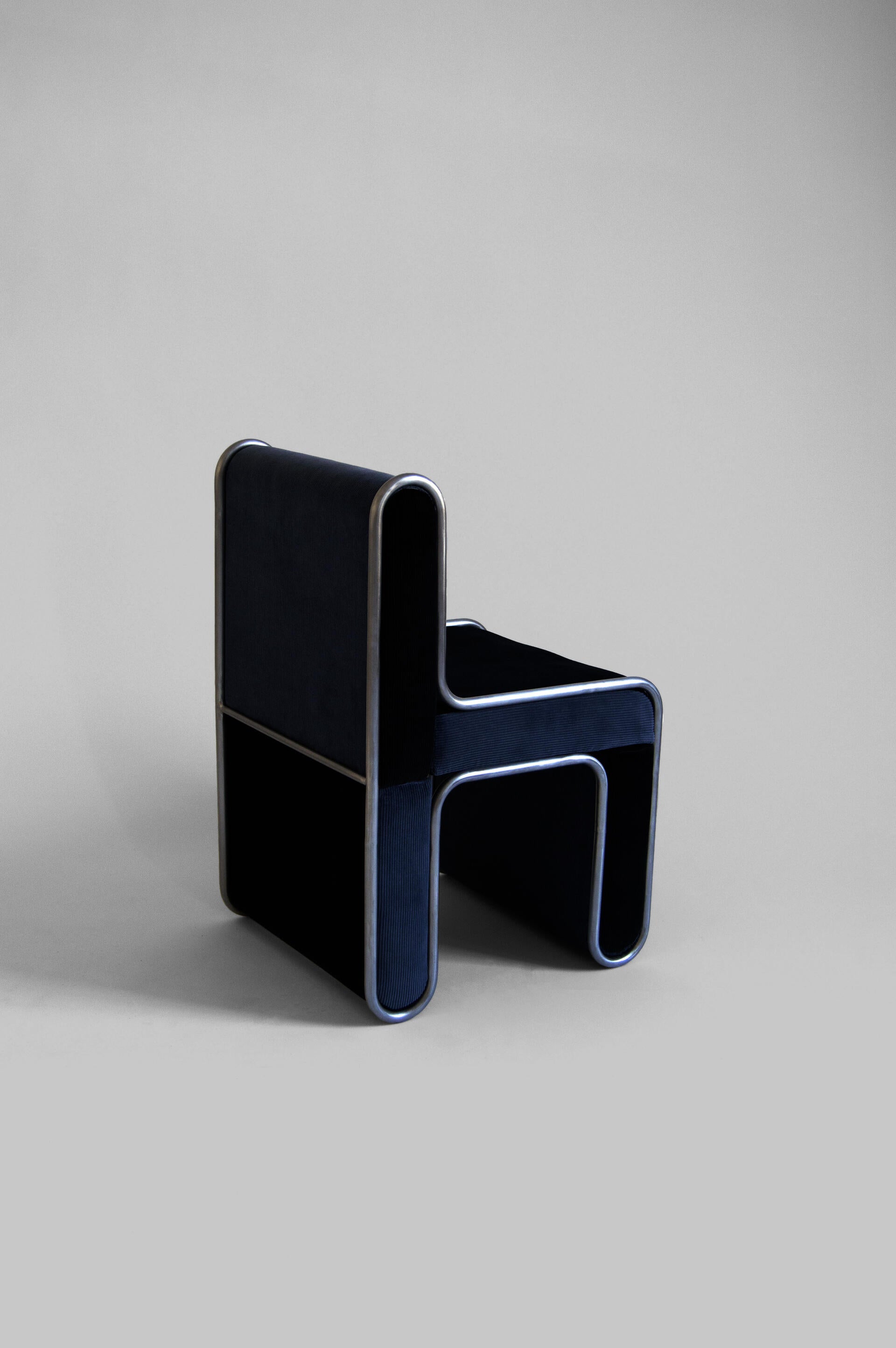 A chair built of upholstered pieces that press fit into a steel structure.
