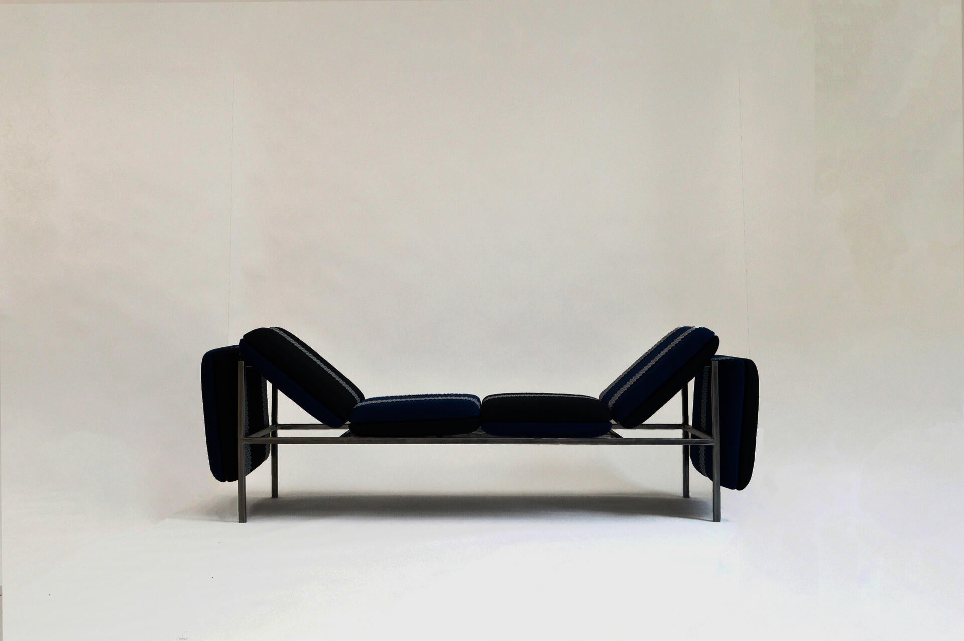 A flexible seating system comprised of tiled, upholstered cushions and held together with webbing.