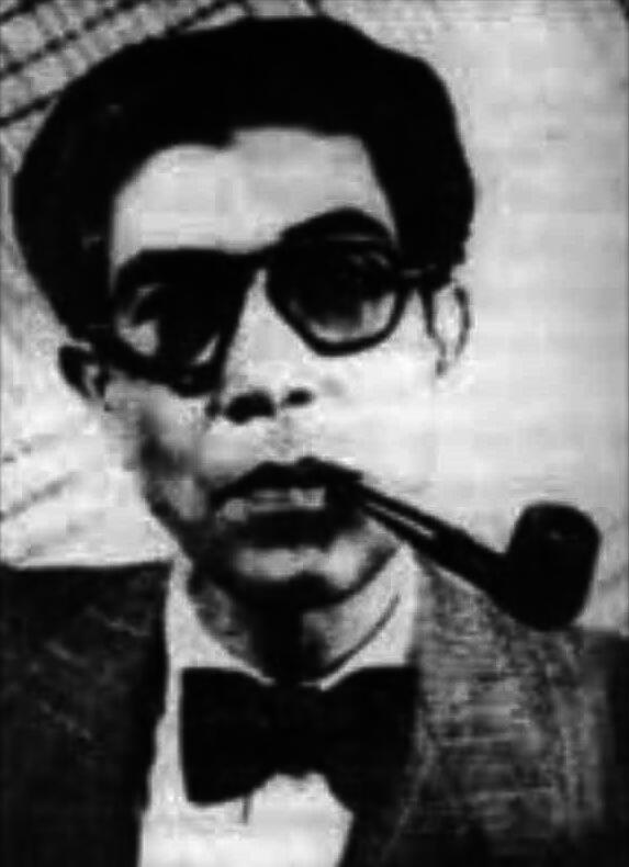A portrait of Ahmed Ali smoking a pipe, circa 1955