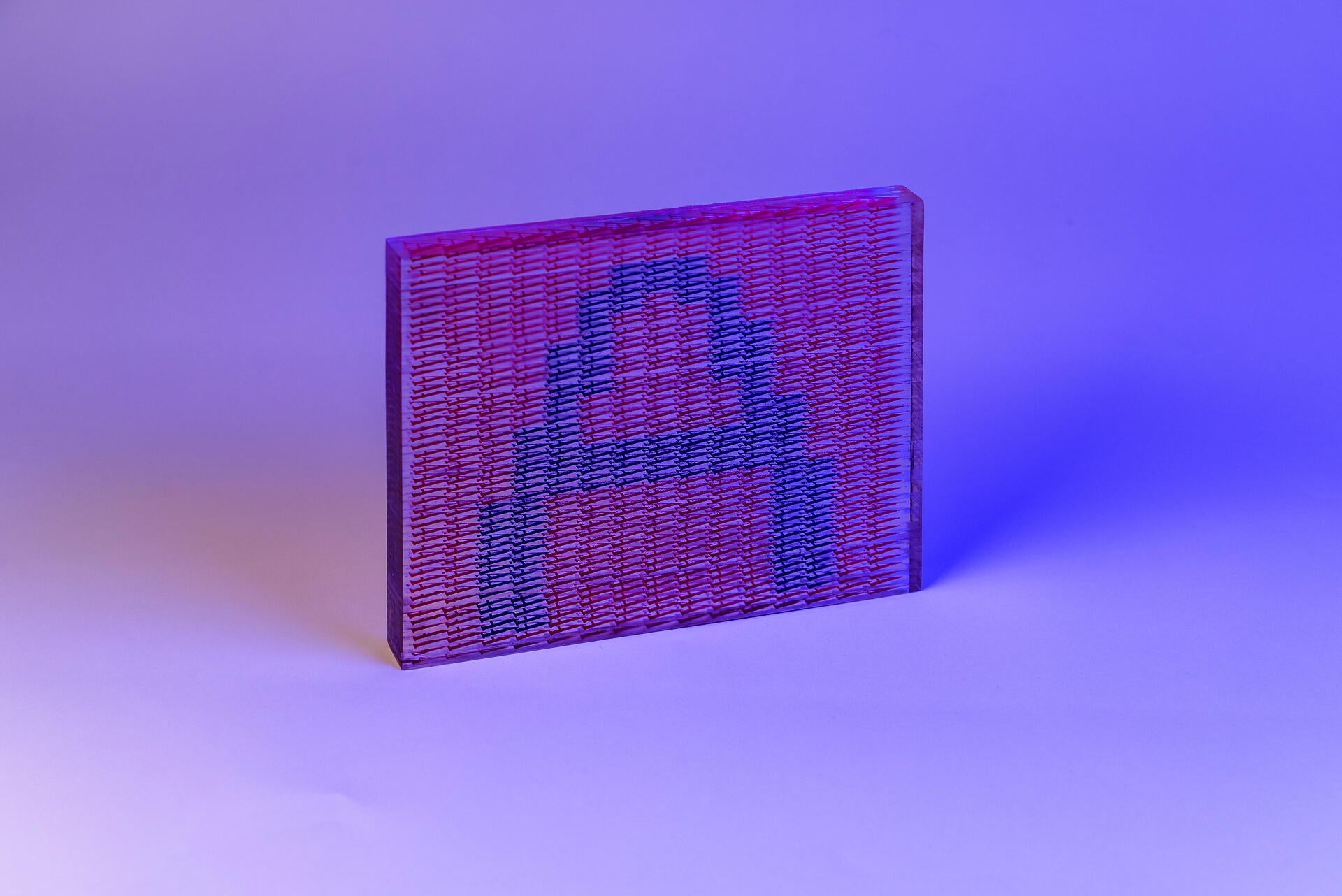 A semi-transparent block, showing a blue letter A against a pink background. In closer inspection, both the image and the background are formed by A is formed by little As.