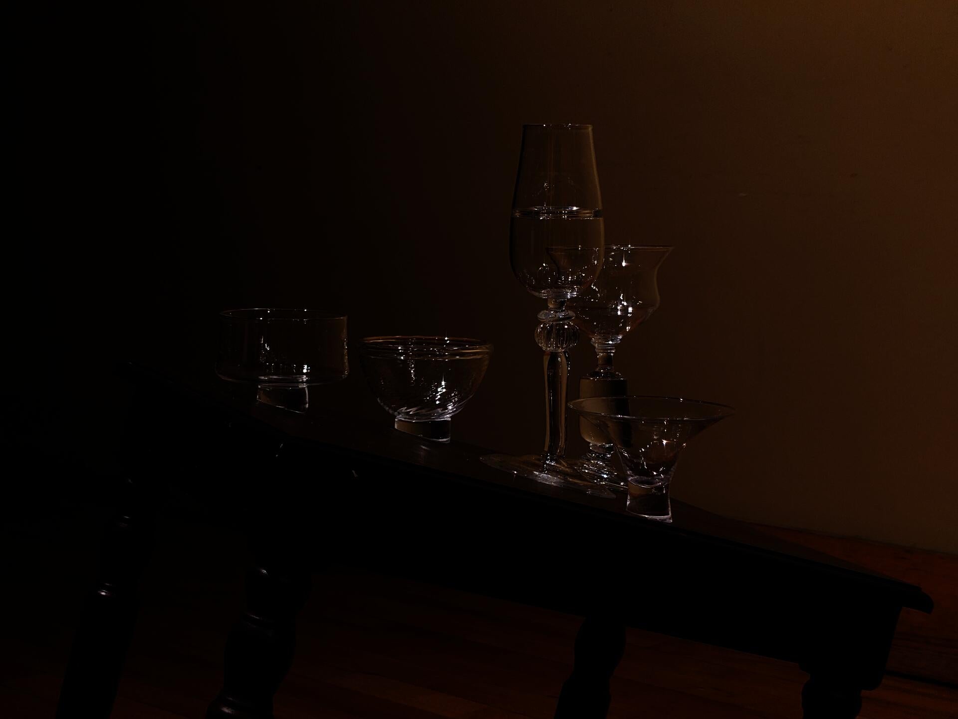 Various hand-blown vessels made to be capable of standing upright on a sloped tabletop.
