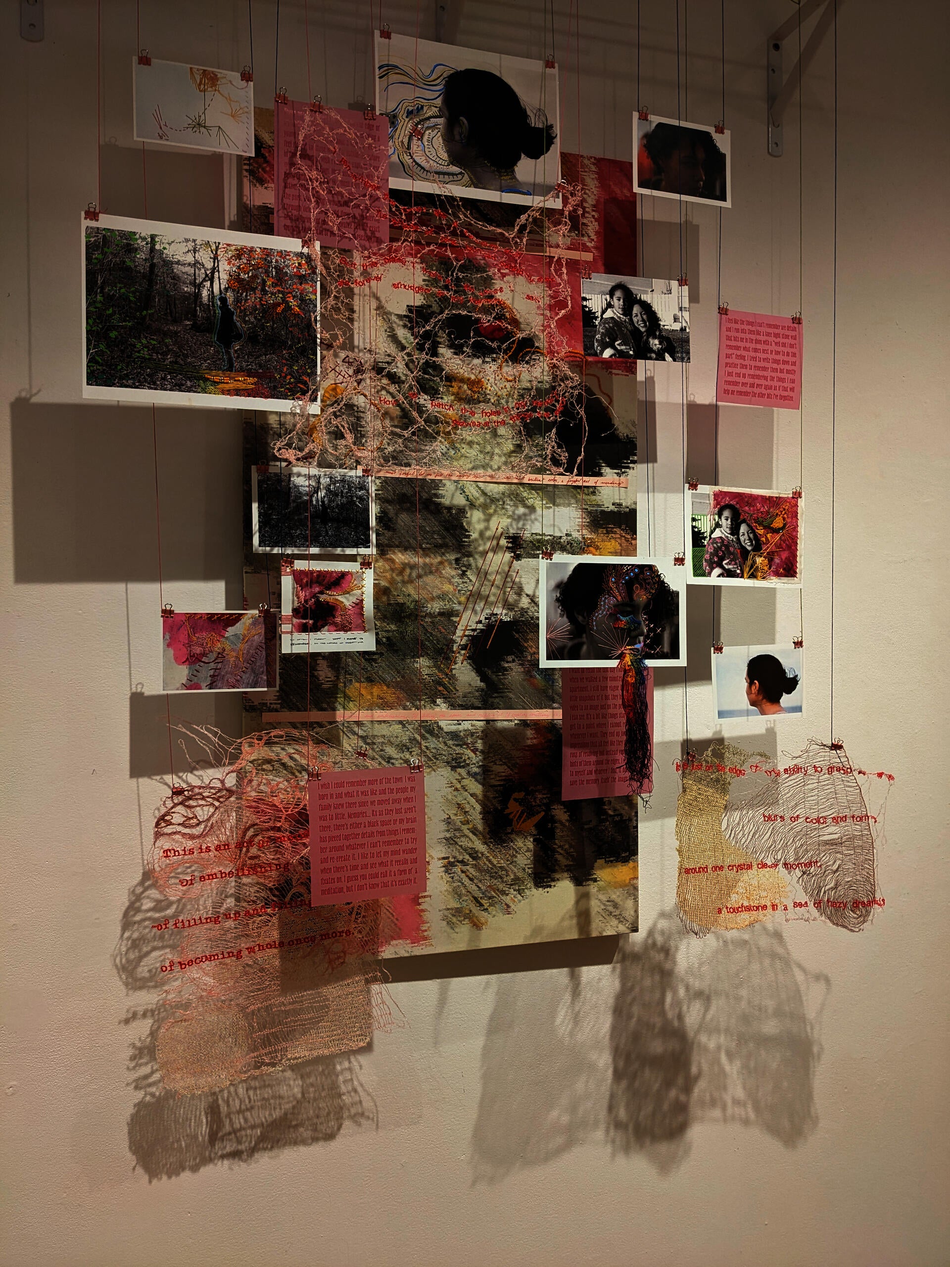 collection of embroidered photographs hanging on strings