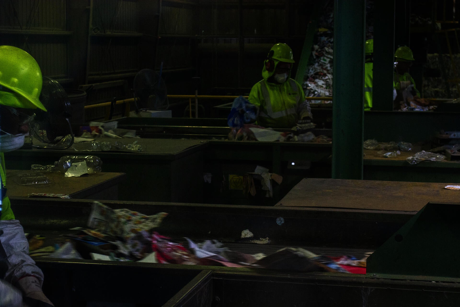 Photograph of two persons manually sorting waste at the Rhode Island Resource Recovery Center