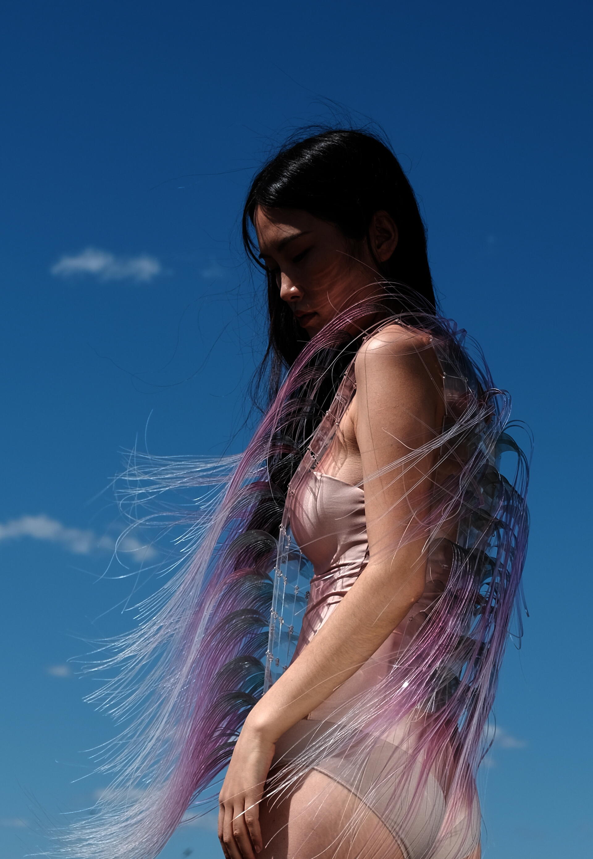 A girl's hair is blowed by wind