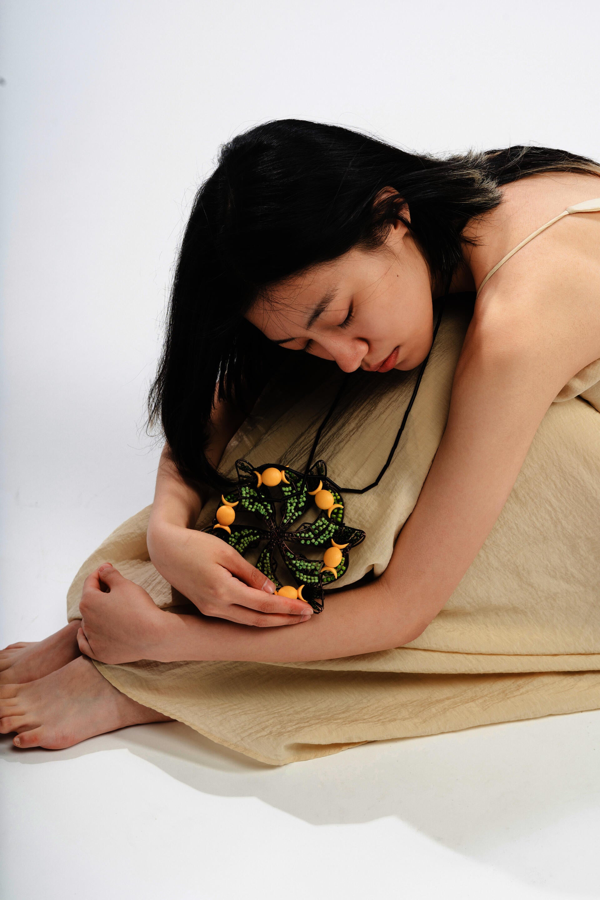 In a profound spiritual dialogue, a woman intimately connects with a powerful possession charm that serves as a transformative catalyst, bringing healing and solace to women affected by domestic abuse, fostering a profound sense of inner calm and emotional tranquility.