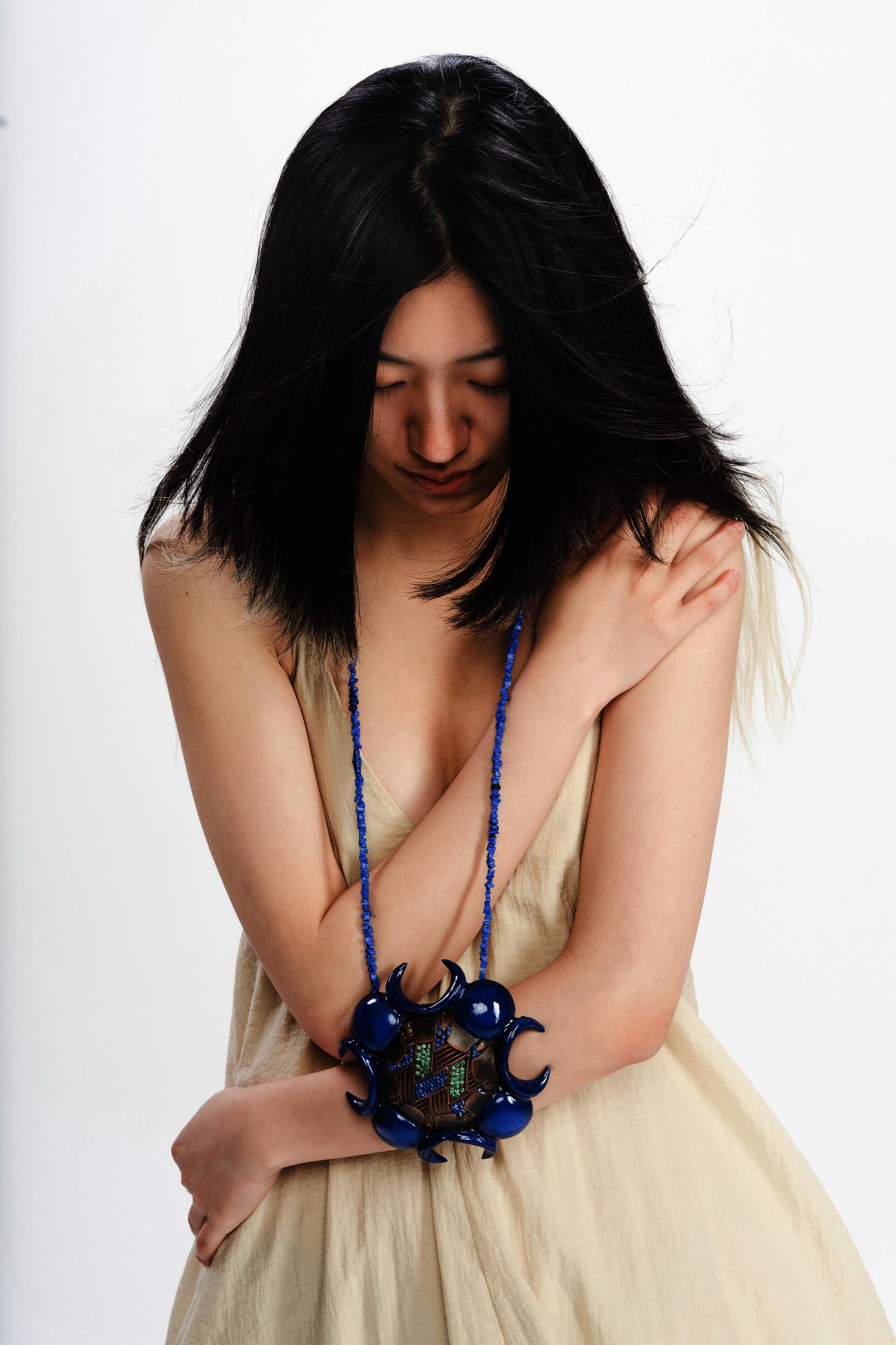 In a profound spiritual dialogue, a woman intimately connects with a powerful possession charm that serves as a transformative catalyst, bringing healing and solace to women affected by domestic abuse, fostering a profound sense of inner calm and emotional tranquility.