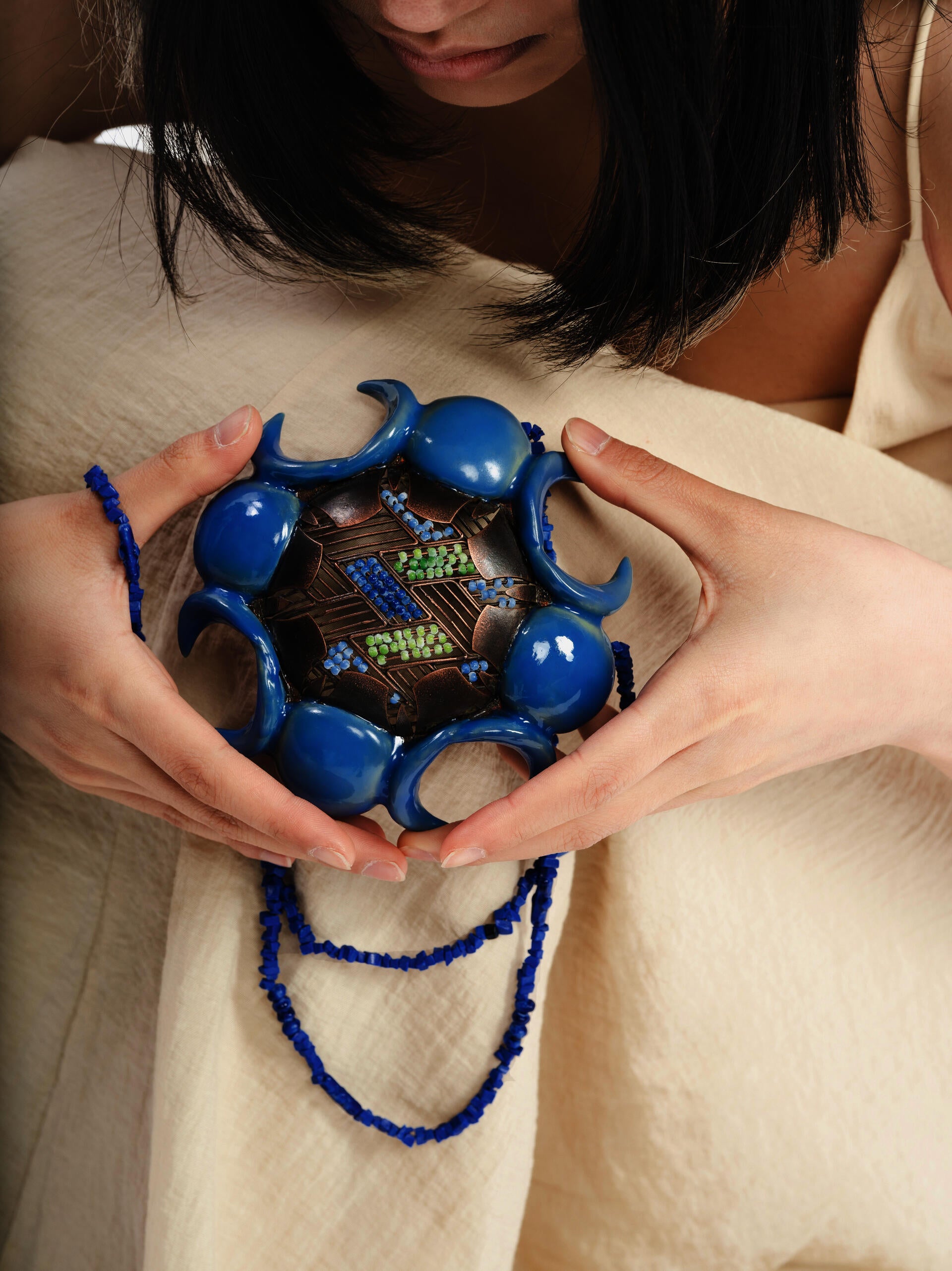 In a profound spiritual dialogue, a woman intimately connects with a powerful possession charm that serves as a transformative catalyst, bringing healing and solace to women affected by domestic abuse, fostering a profound sense of inner calm and emotional tranquility.