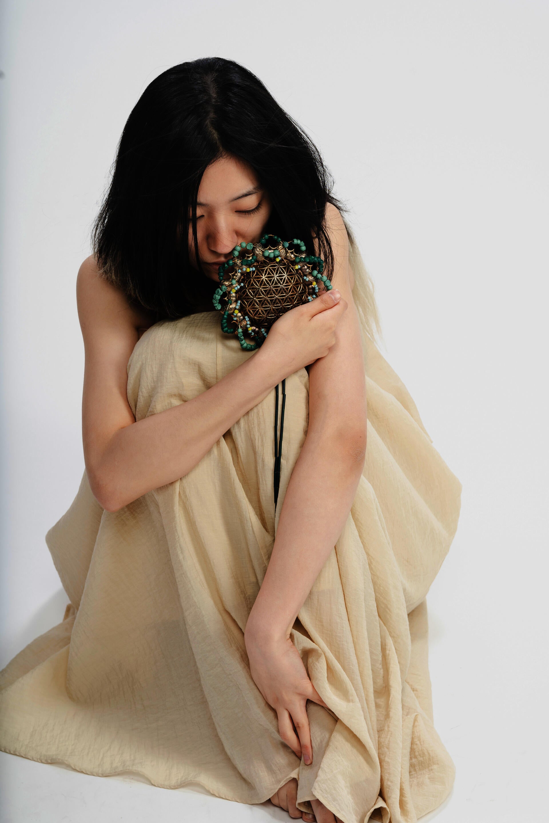 In a profound spiritual dialogue, a woman intimately connects with a powerful possession charm that serves as a transformative catalyst, bringing healing and solace to women affected by domestic abuse, fostering a profound sense of inner calm and emotional tranquility.