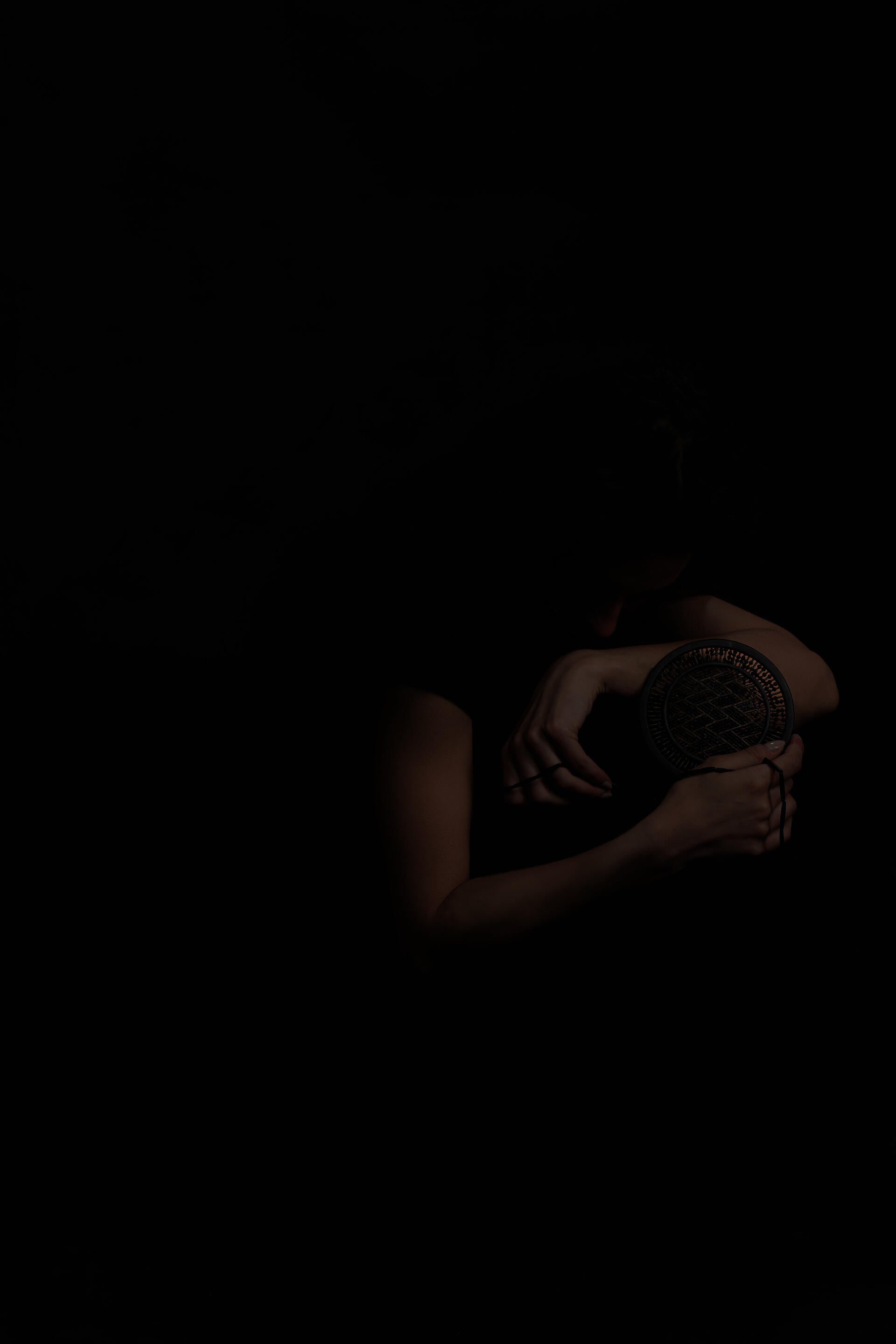 In a profound spiritual dialogue, a woman intimately connects with a powerful possession charm that serves as a transformative catalyst, bringing healing and solace to women affected by domestic abuse, fostering a profound sense of inner calm and emotional tranquility.