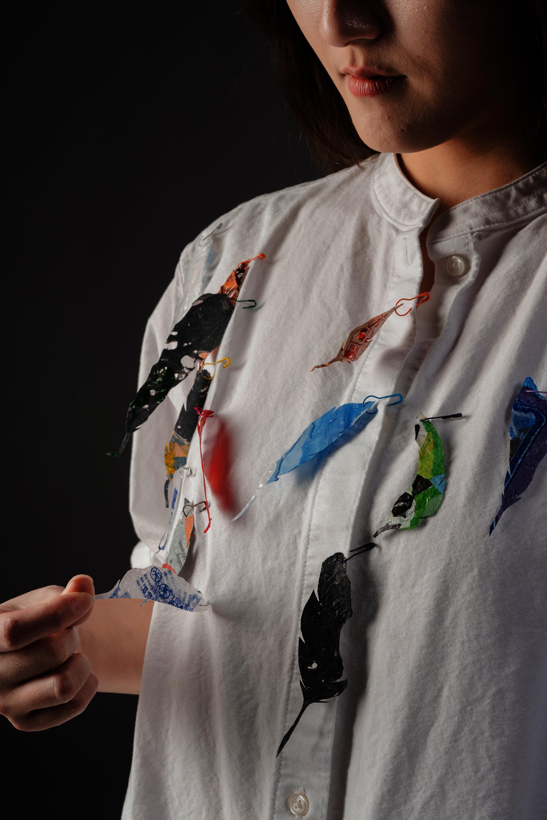 Photo of model wearing feather brooches