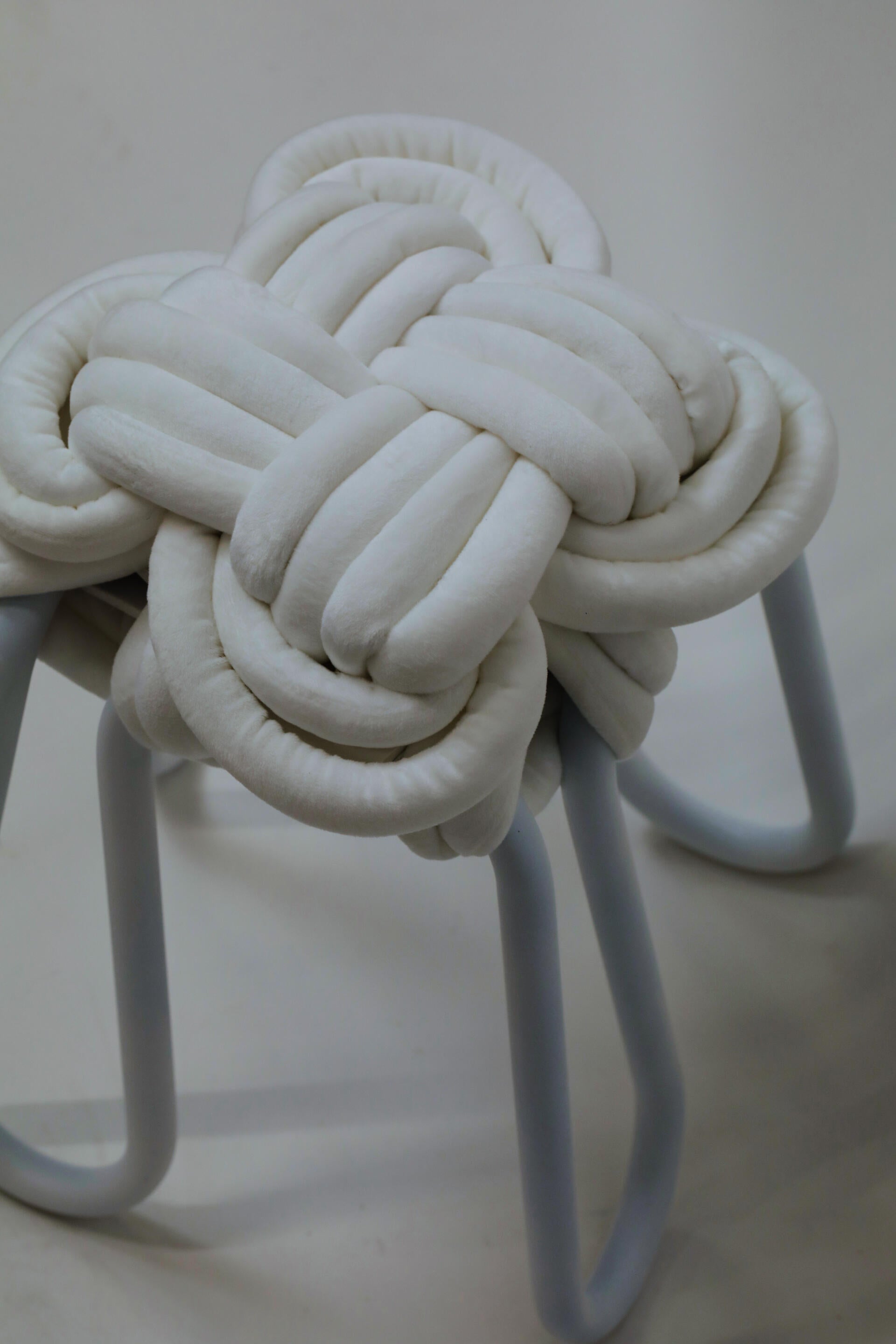 Close view of white knot stool on a white background