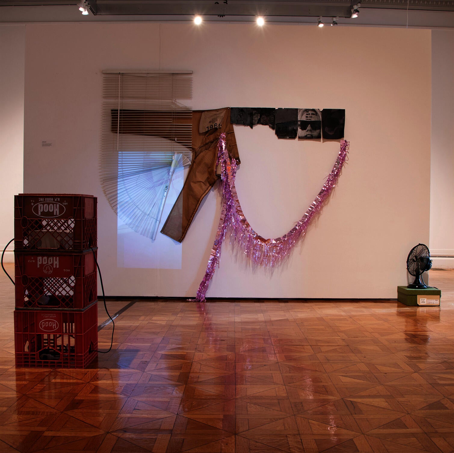 cardboard cutouts with mixed-media mounted in a series of arching manner
