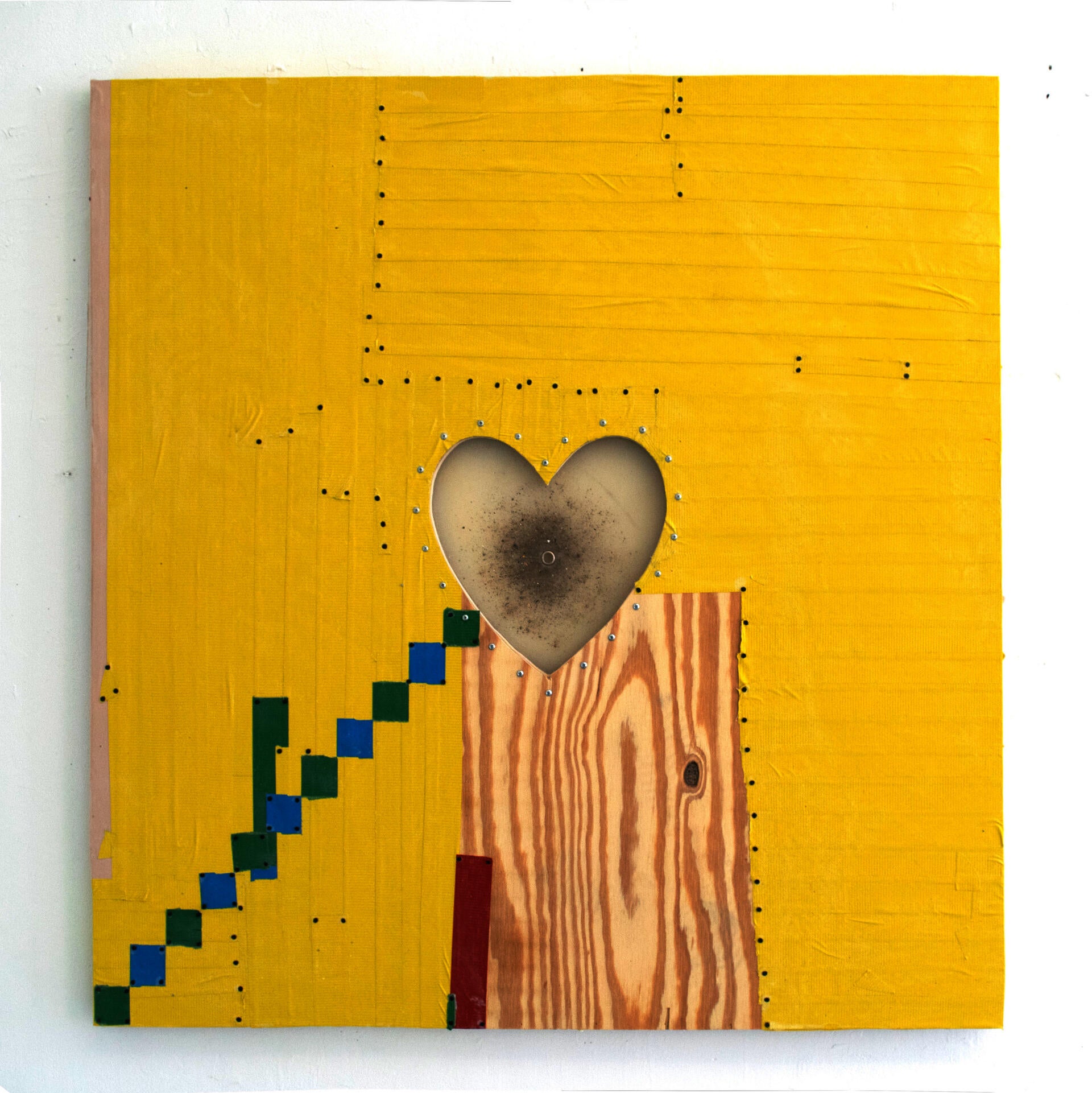 A silicone heart shape dominates a wood panel, skinned in yellow duct tape, the seams of which are sealed with black furniture tacks.