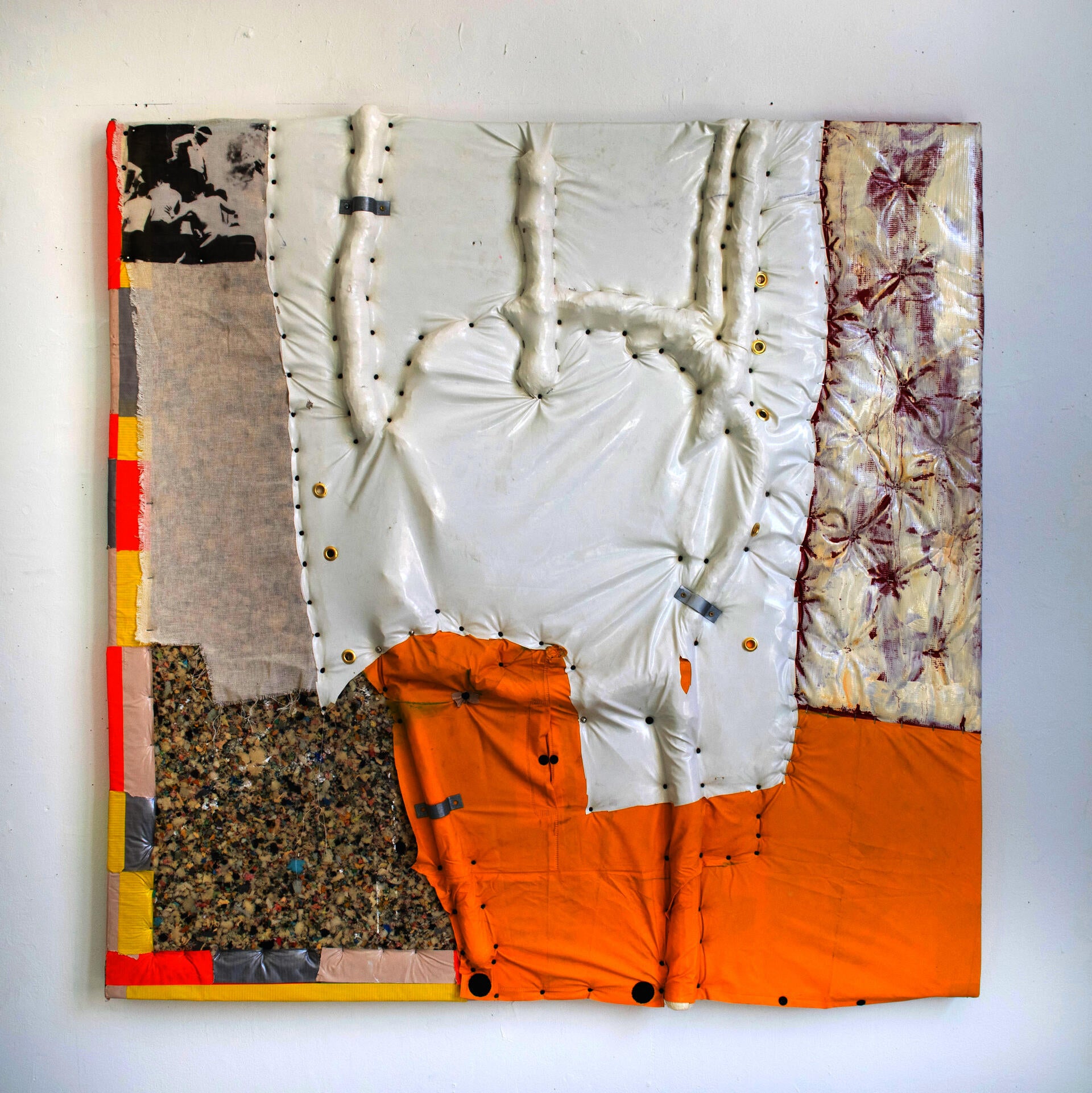 a painting-sculpture hybrid object cobbled together from various fabrics and materials