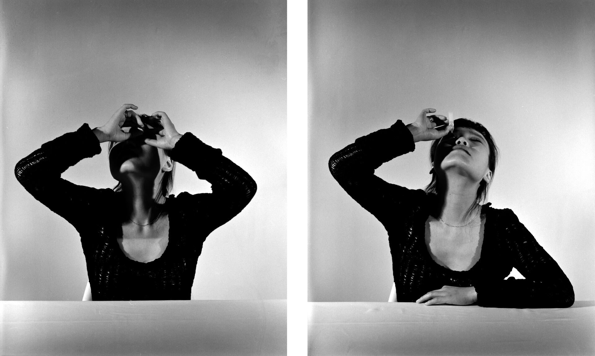 A girl dropping eyedrops into both left and right eyes.