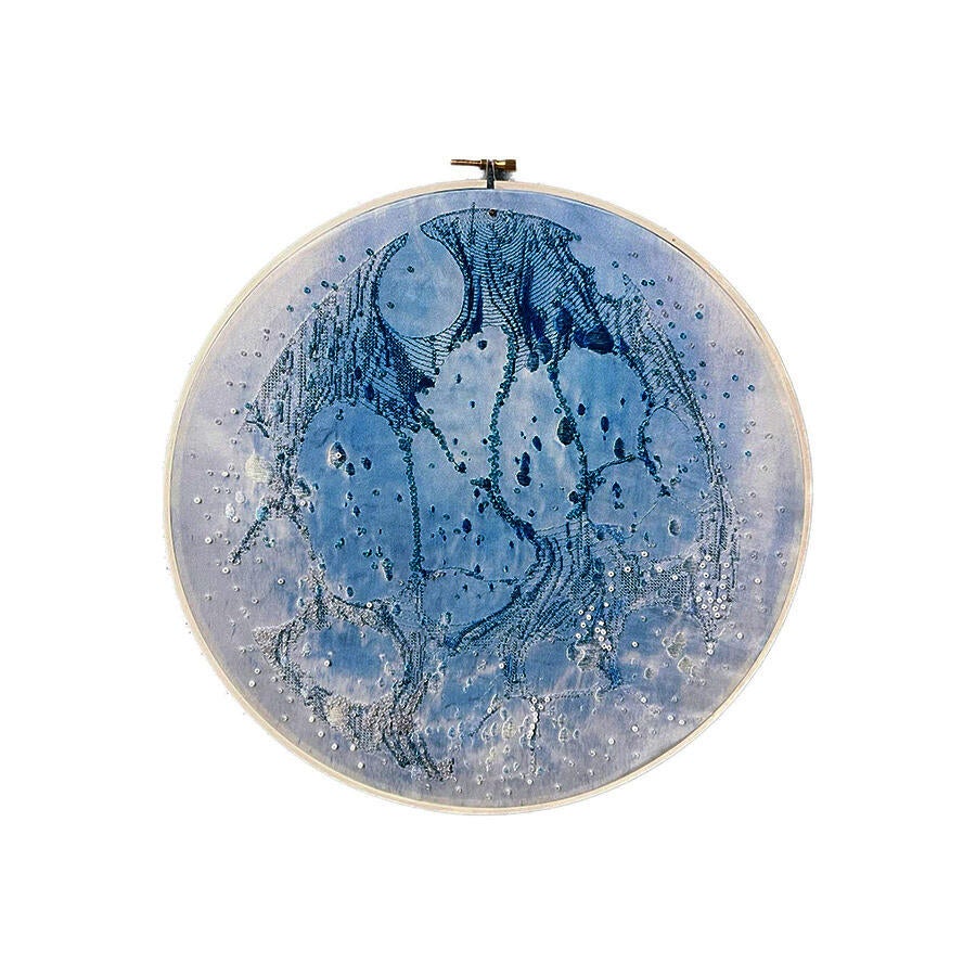 On a round piece of silk dyed light blue by the cyanotype, I made some patterns like the moon sea by embroidery.
